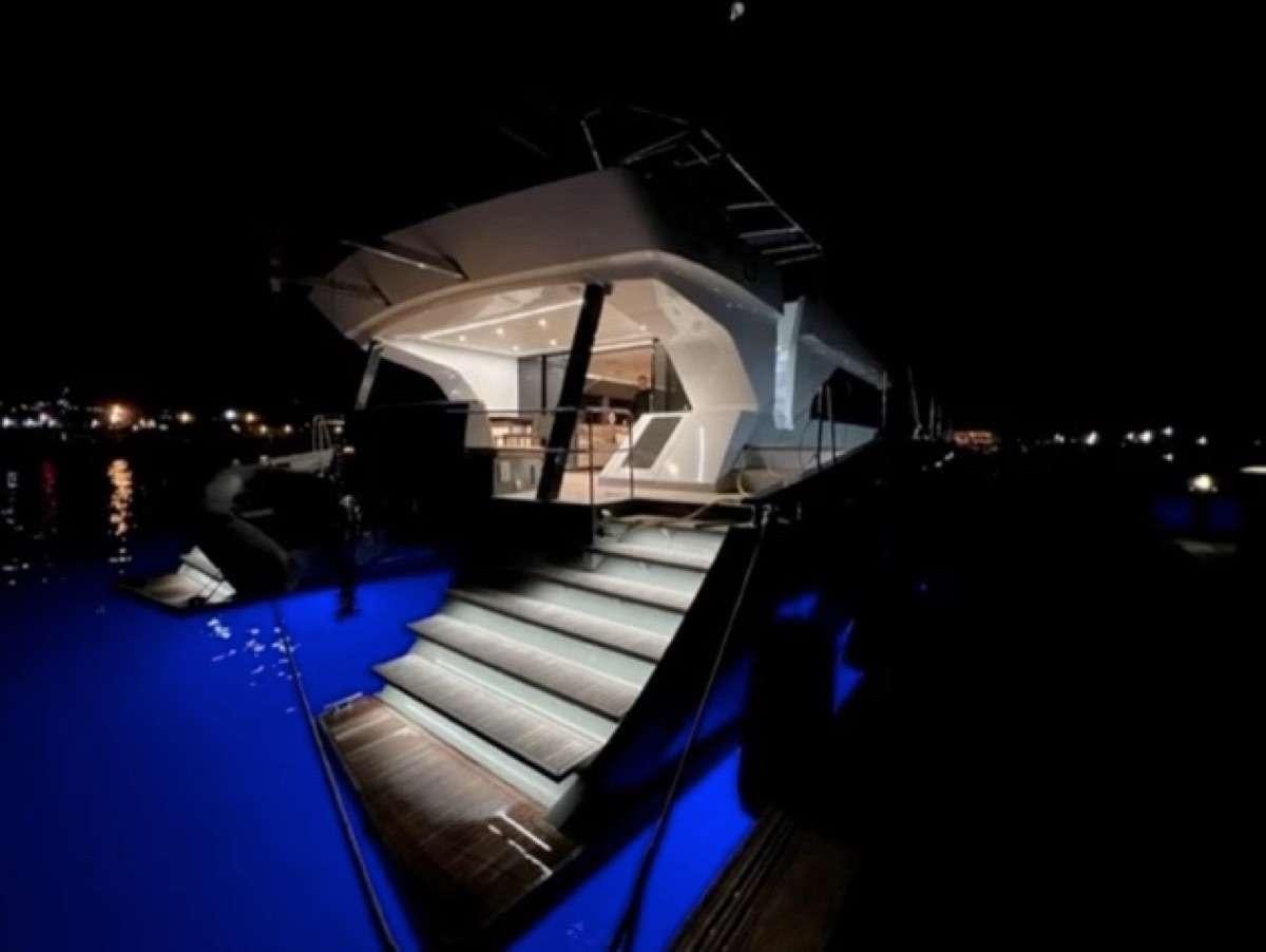 a building with a pool at night aboard MOON DRAGON Yacht for Charter