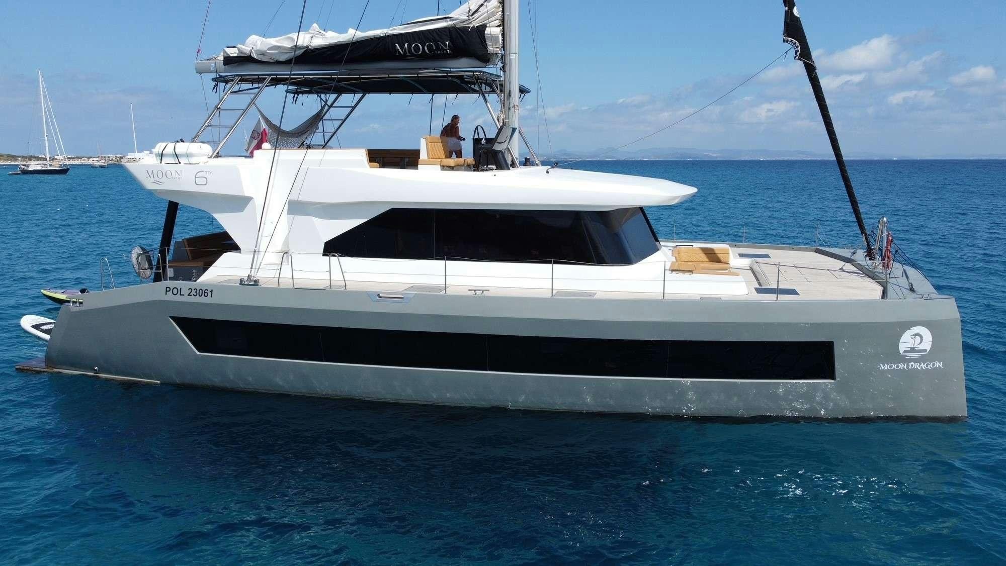 a white boat in the water aboard MOON DRAGON Yacht for Charter