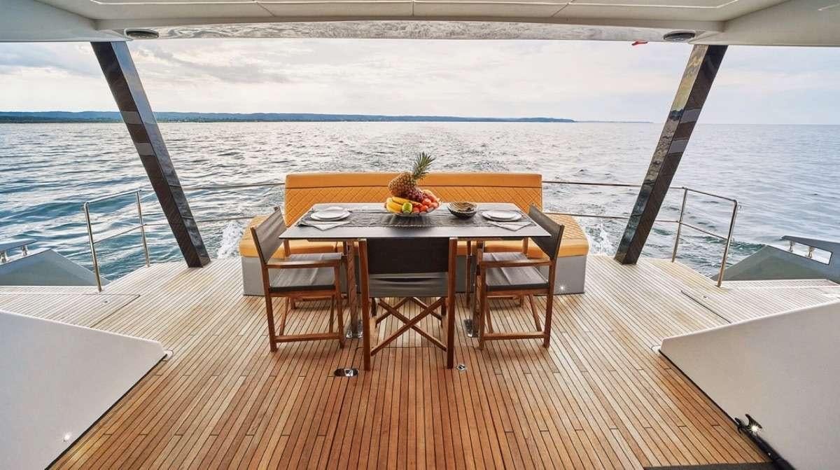 a table and chairs on a deck aboard MOON DRAGON Yacht for Charter