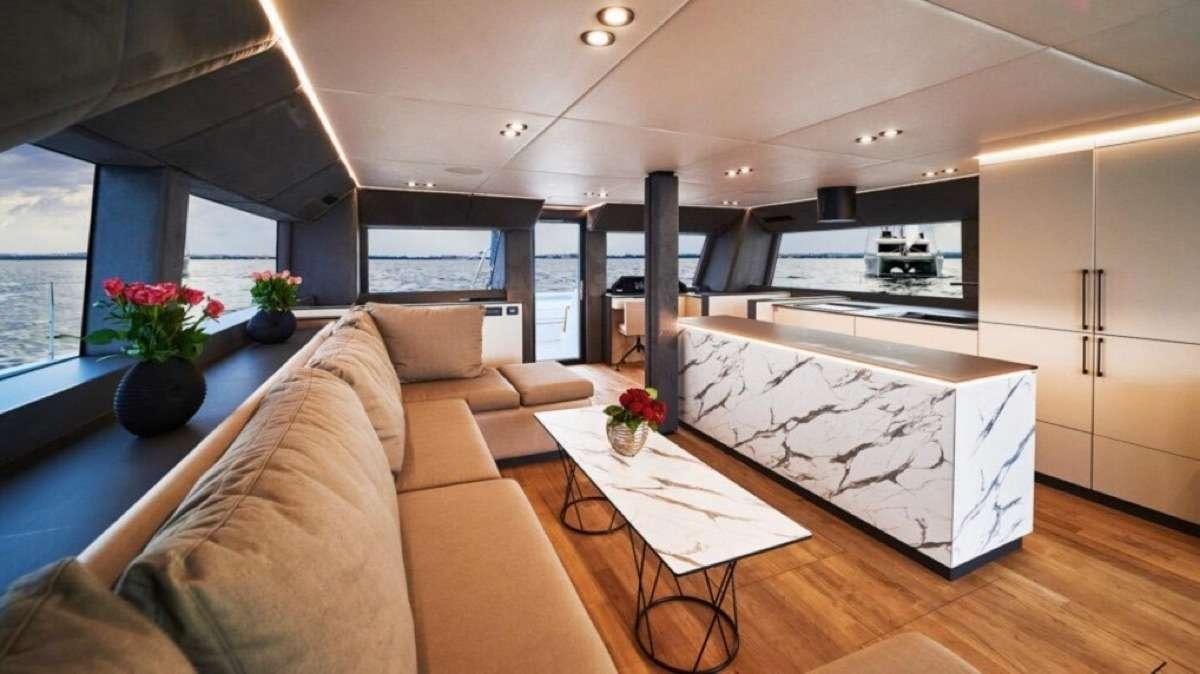 a living room with a couch and a table aboard MOON DRAGON Yacht for Charter