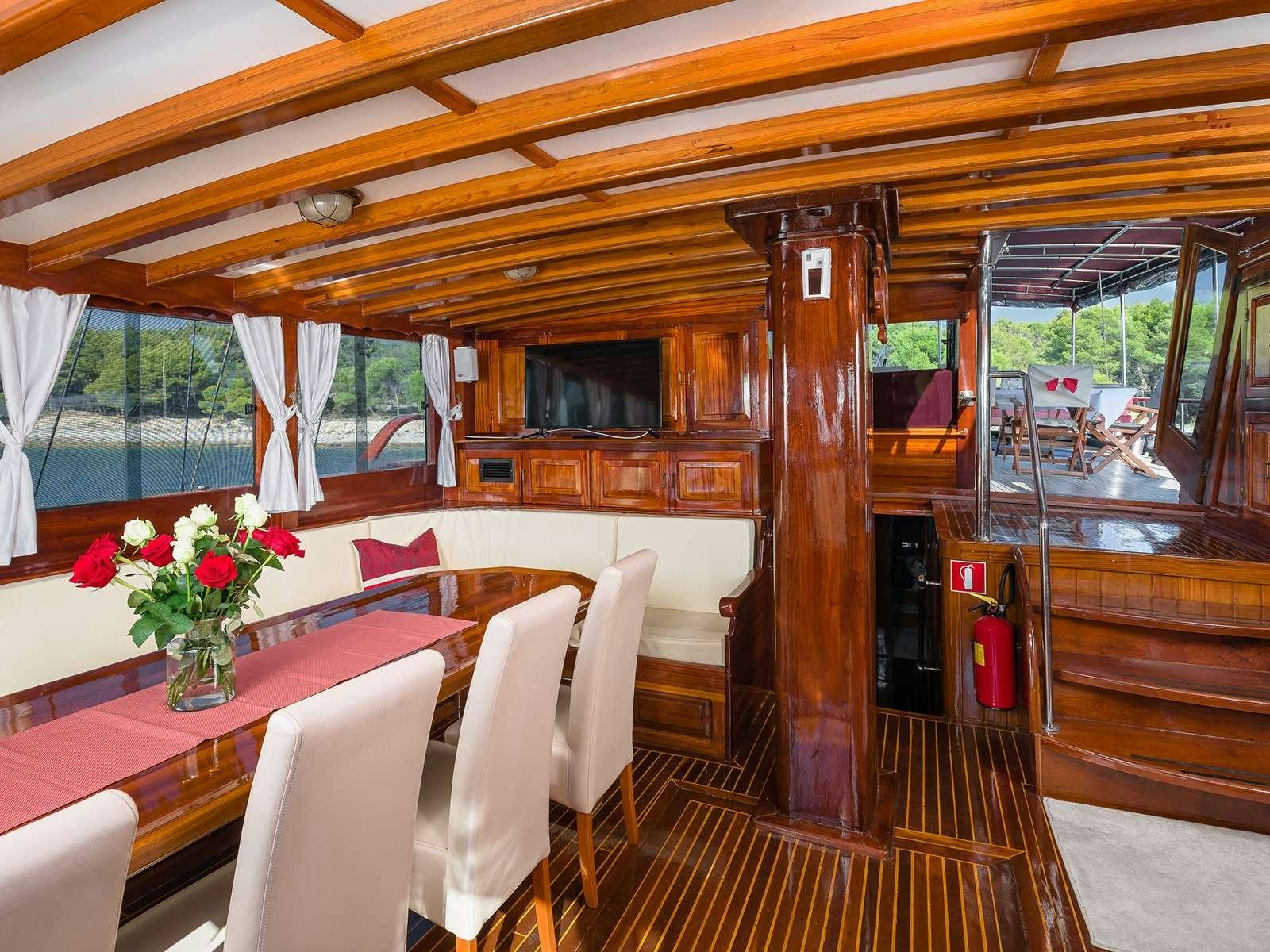 a room with a table and chairs aboard GULET CROATIA Yacht for Charter
