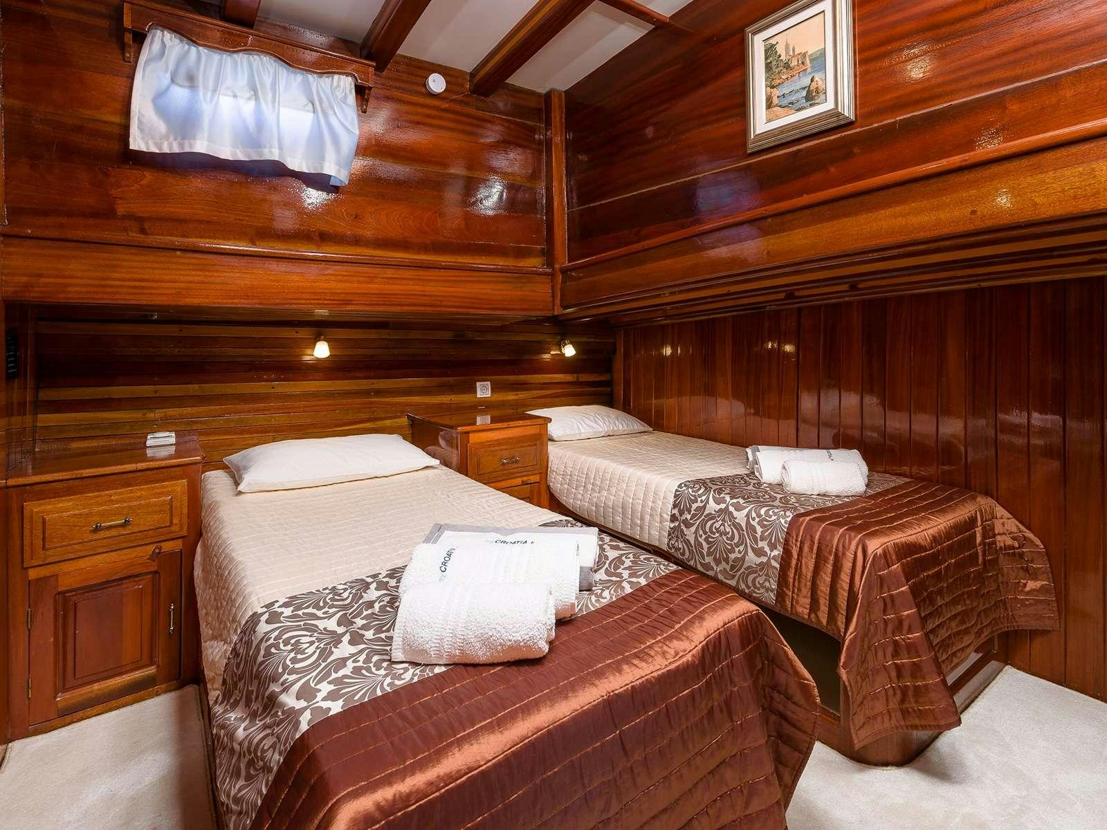 a room with beds and a wood wall aboard GULET CROATIA Yacht for Charter