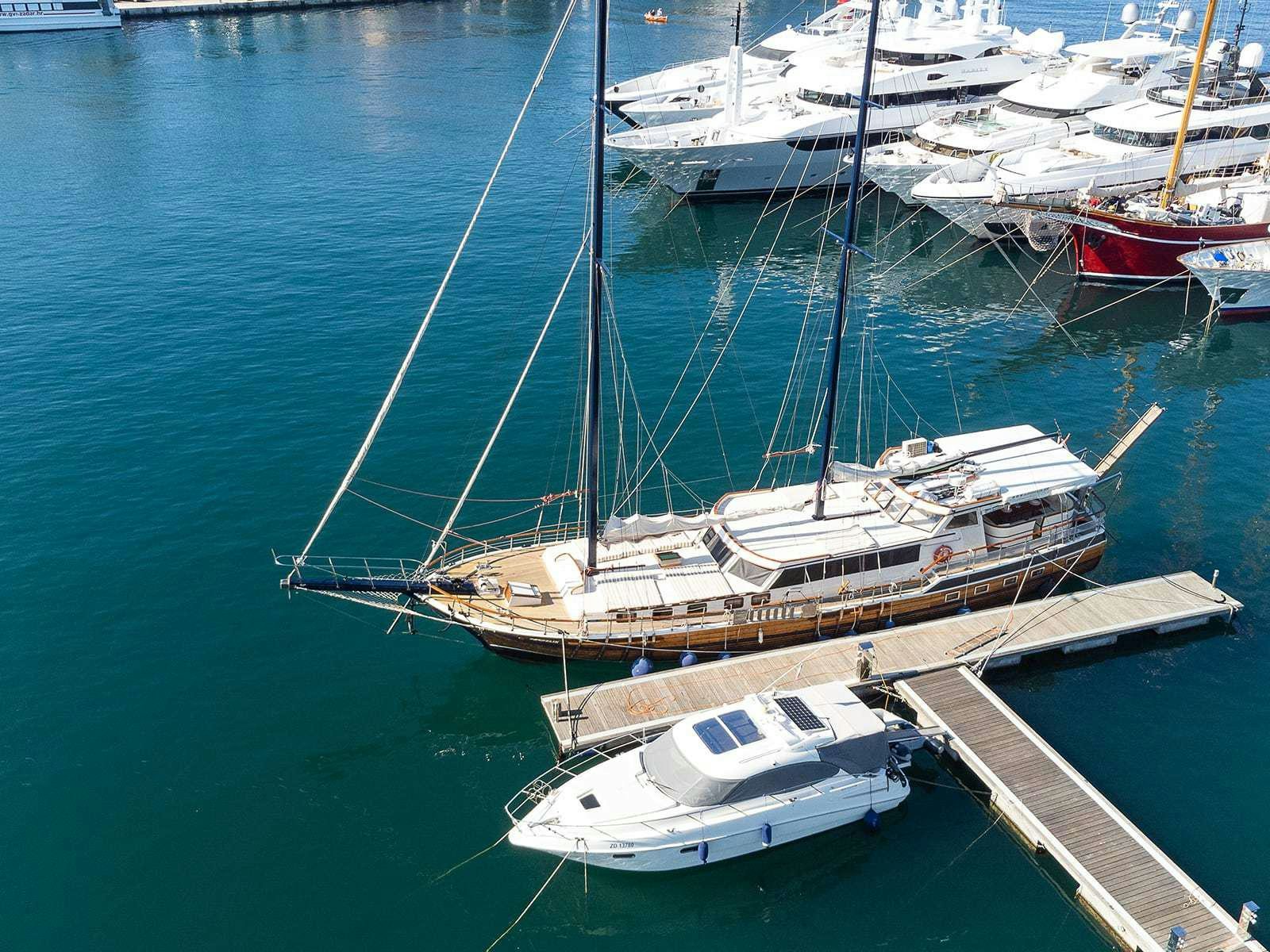 a group of boats are parked in the water aboard Gulet Gardelin Yacht for Charter
