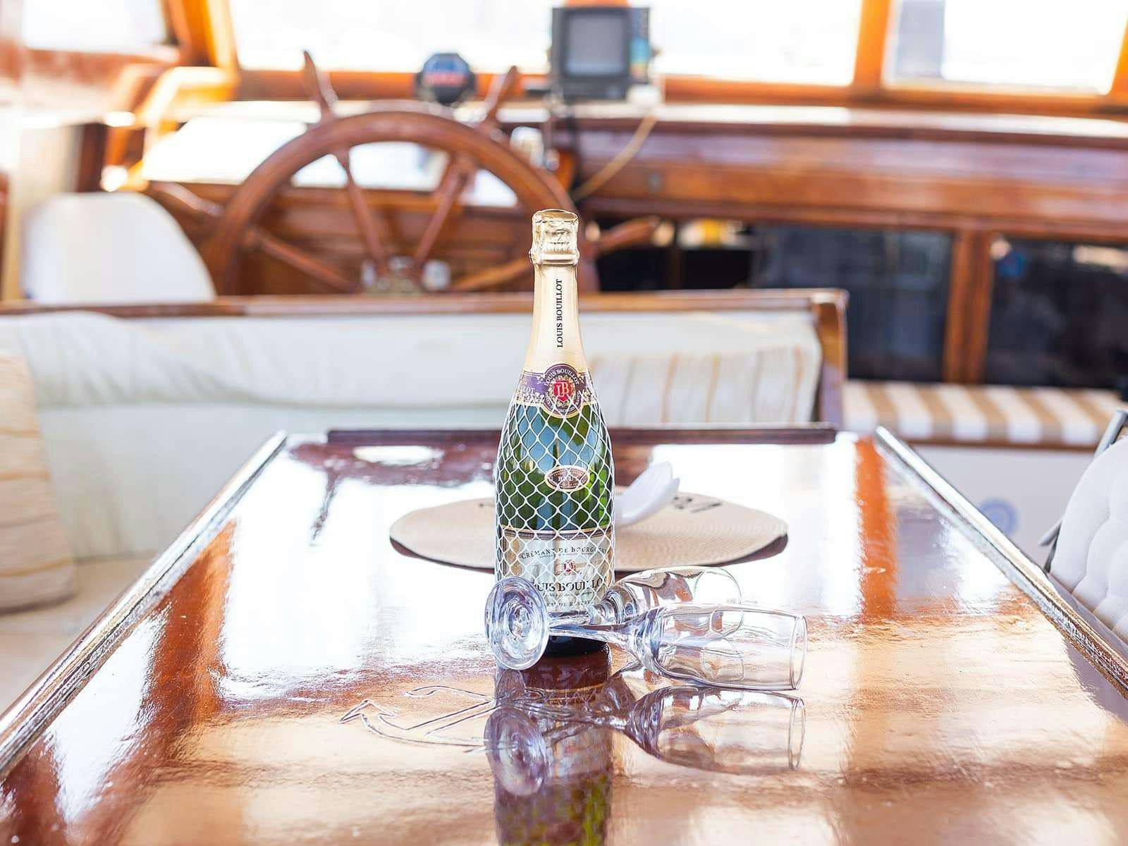a bottle of alcohol on a table aboard Gulet Gardelin Yacht for Charter