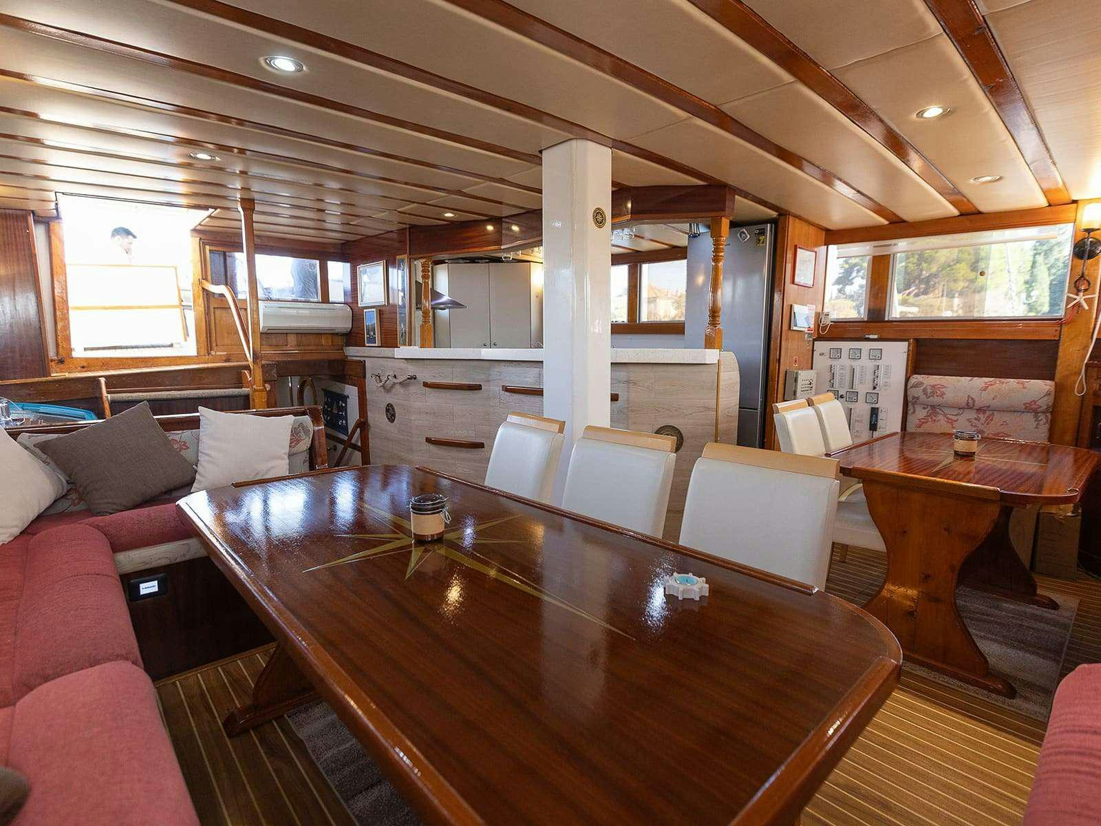 a large room with a table and chairs aboard Gulet Gardelin Yacht for Charter