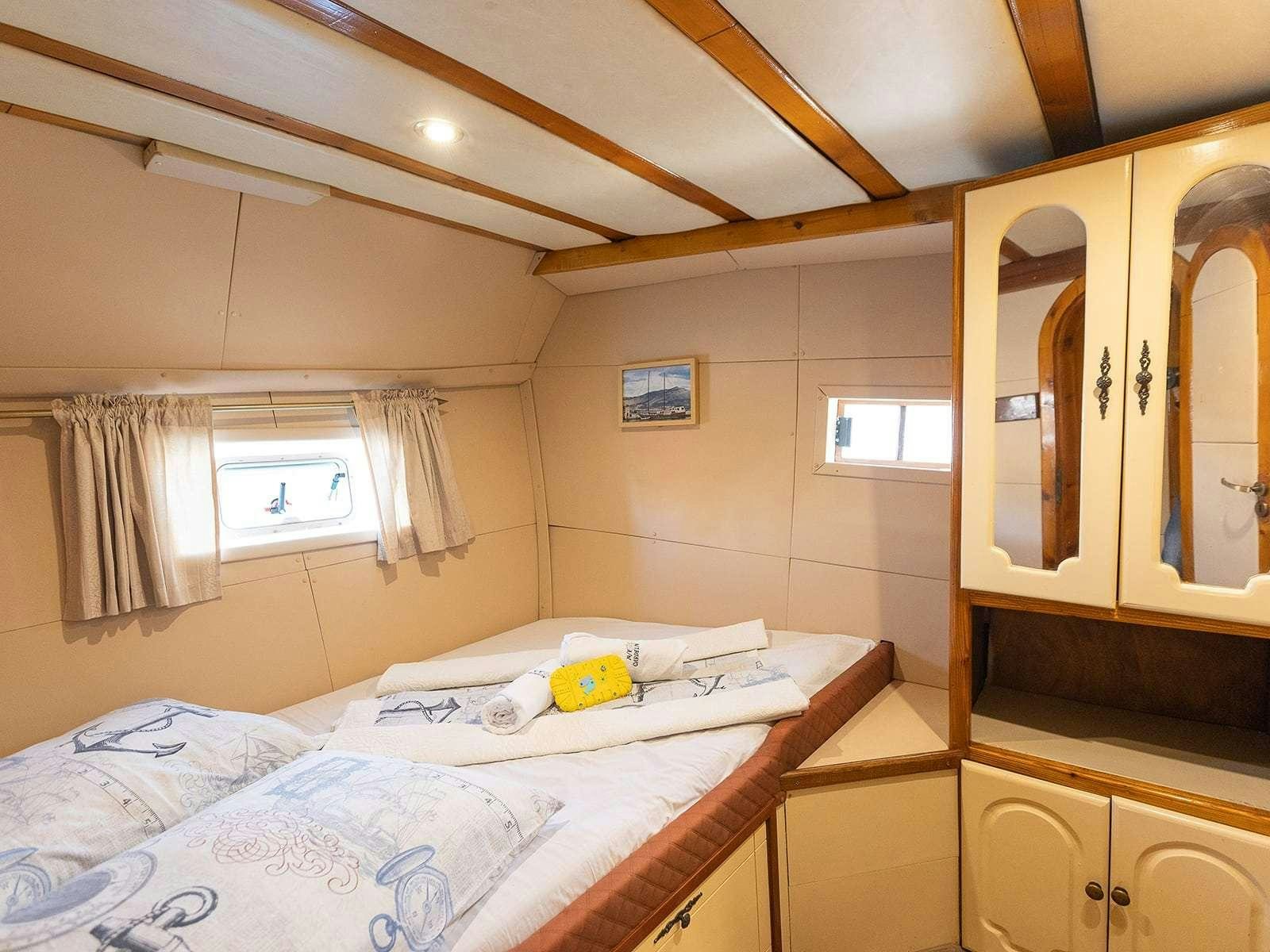 a bedroom with two beds aboard Gulet Gardelin Yacht for Charter