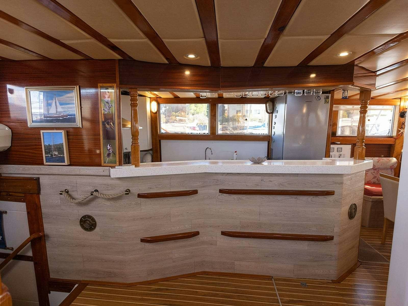 a large kitchen with wooden cabinets aboard Gulet Gardelin Yacht for Charter