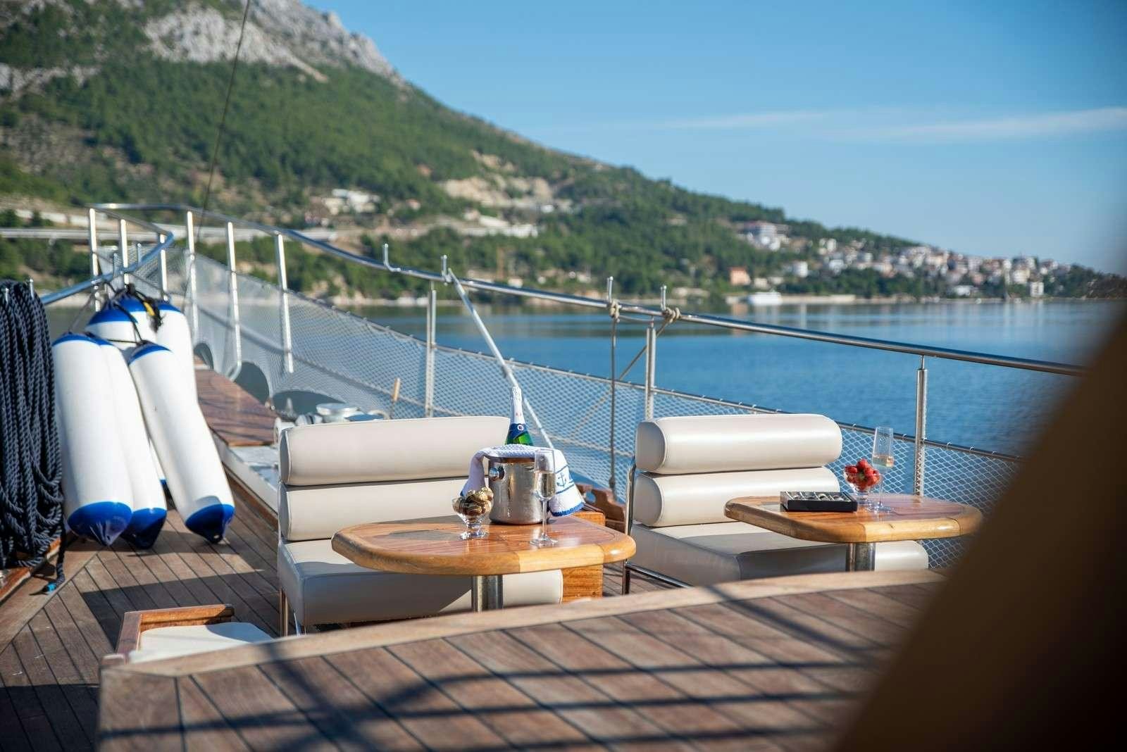 a boat on a deck aboard Trebenna Yacht for Charter