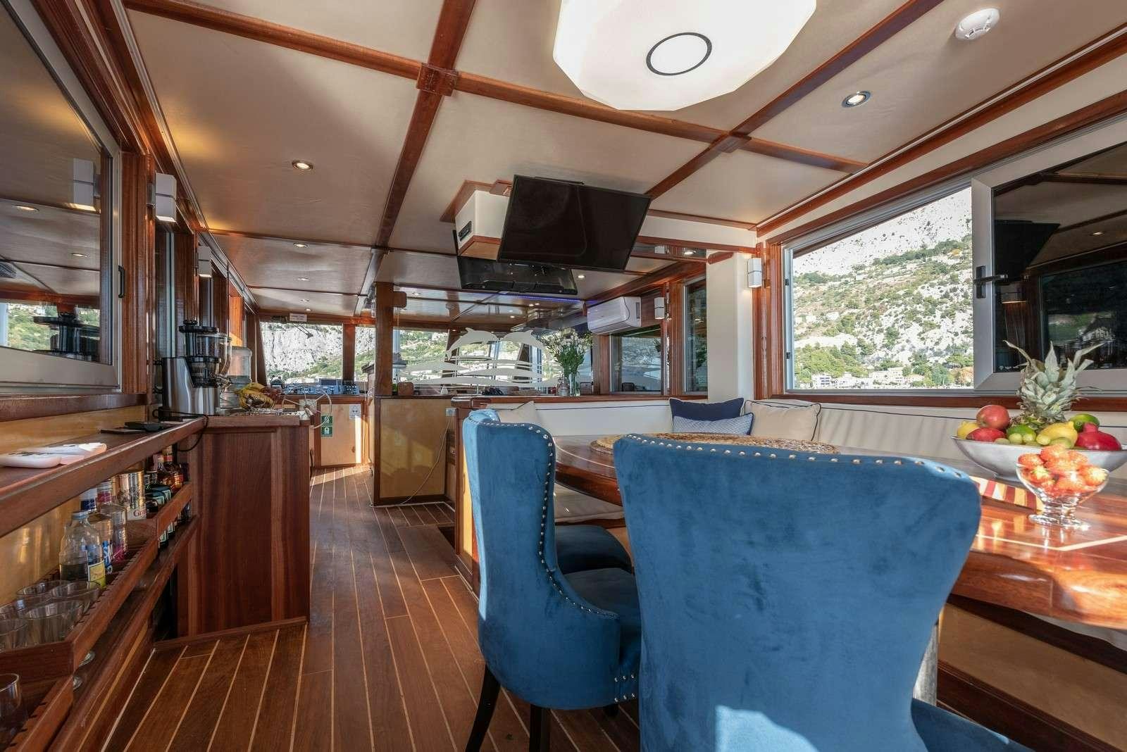 a kitchen with a wood floor aboard Trebenna Yacht for Charter