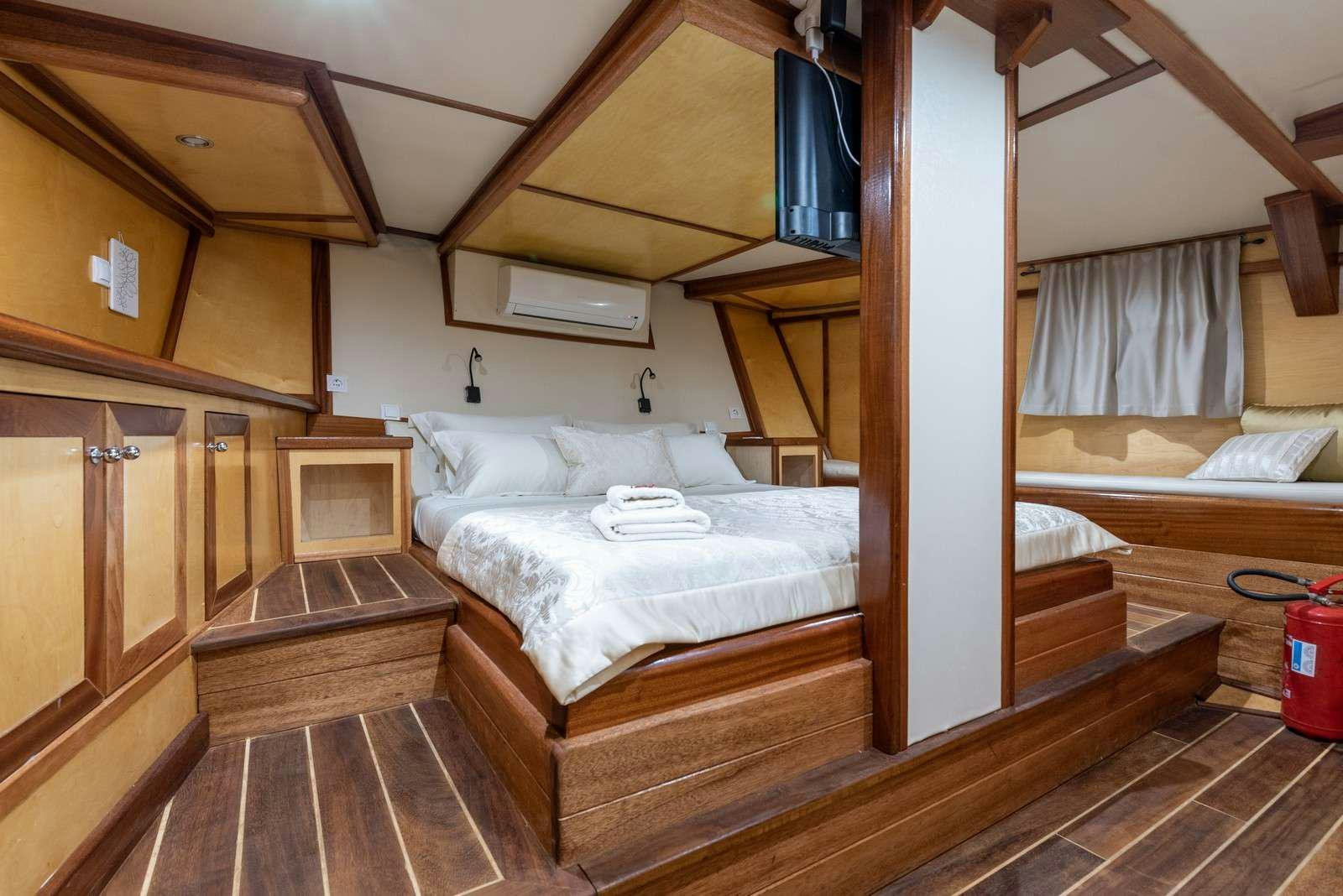 a room with wooden furniture aboard Trebenna Yacht for Charter