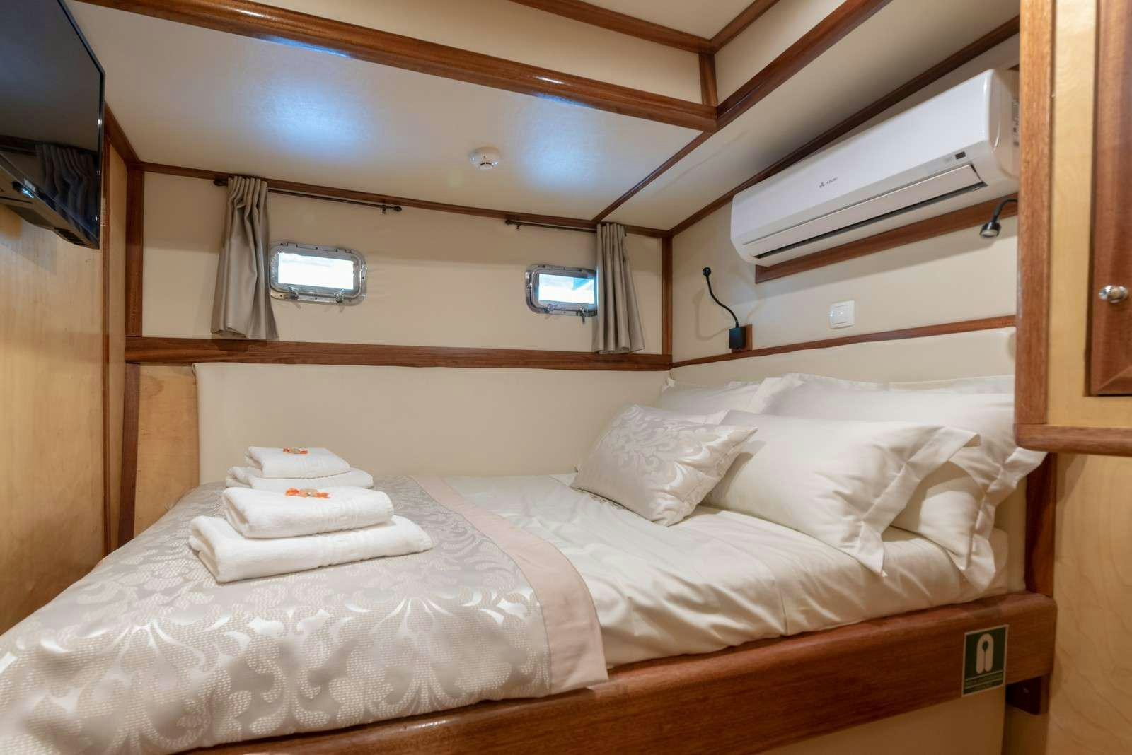 a room with two beds aboard Trebenna Yacht for Charter