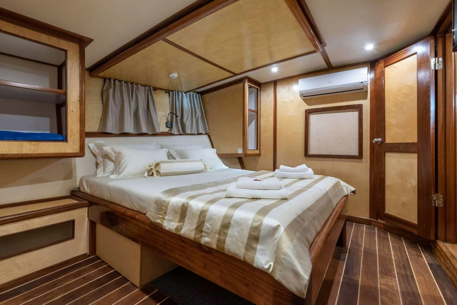 a bed in a room aboard Trebenna Yacht for Charter
