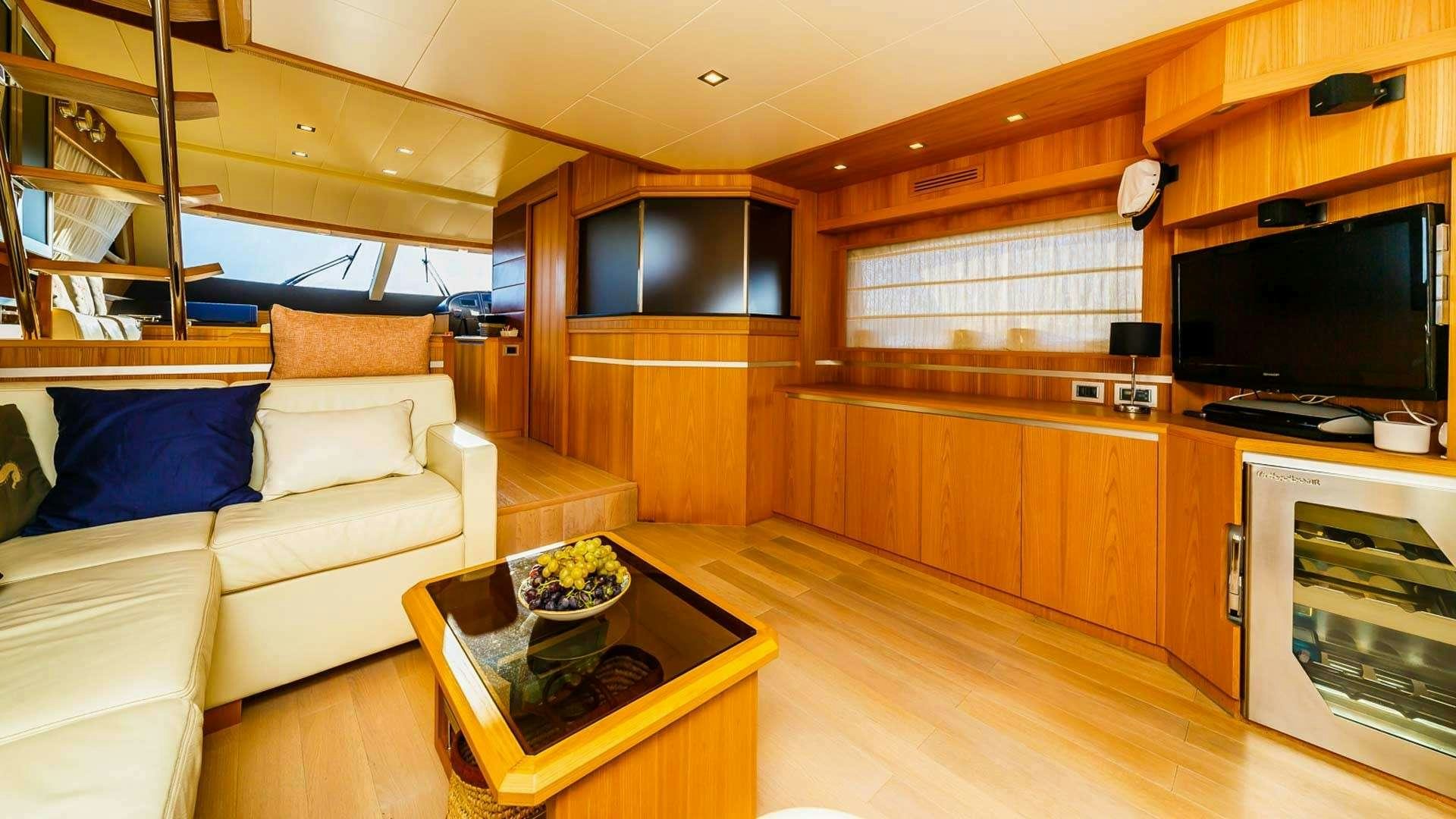 a living room with a couch and a television aboard SECRET LIFE Yacht for Charter