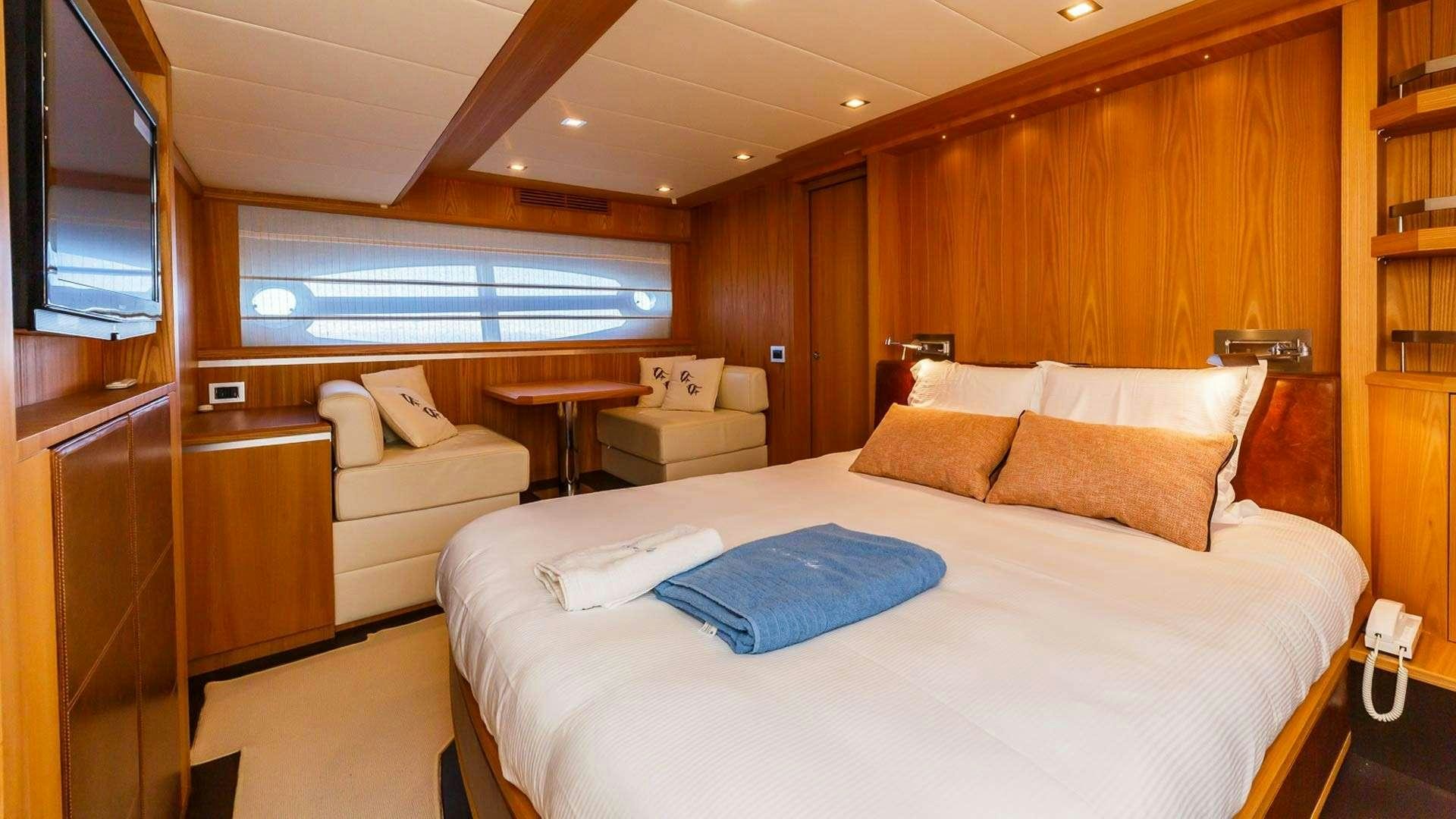 a room with a bed and a table aboard SECRET LIFE Yacht for Charter