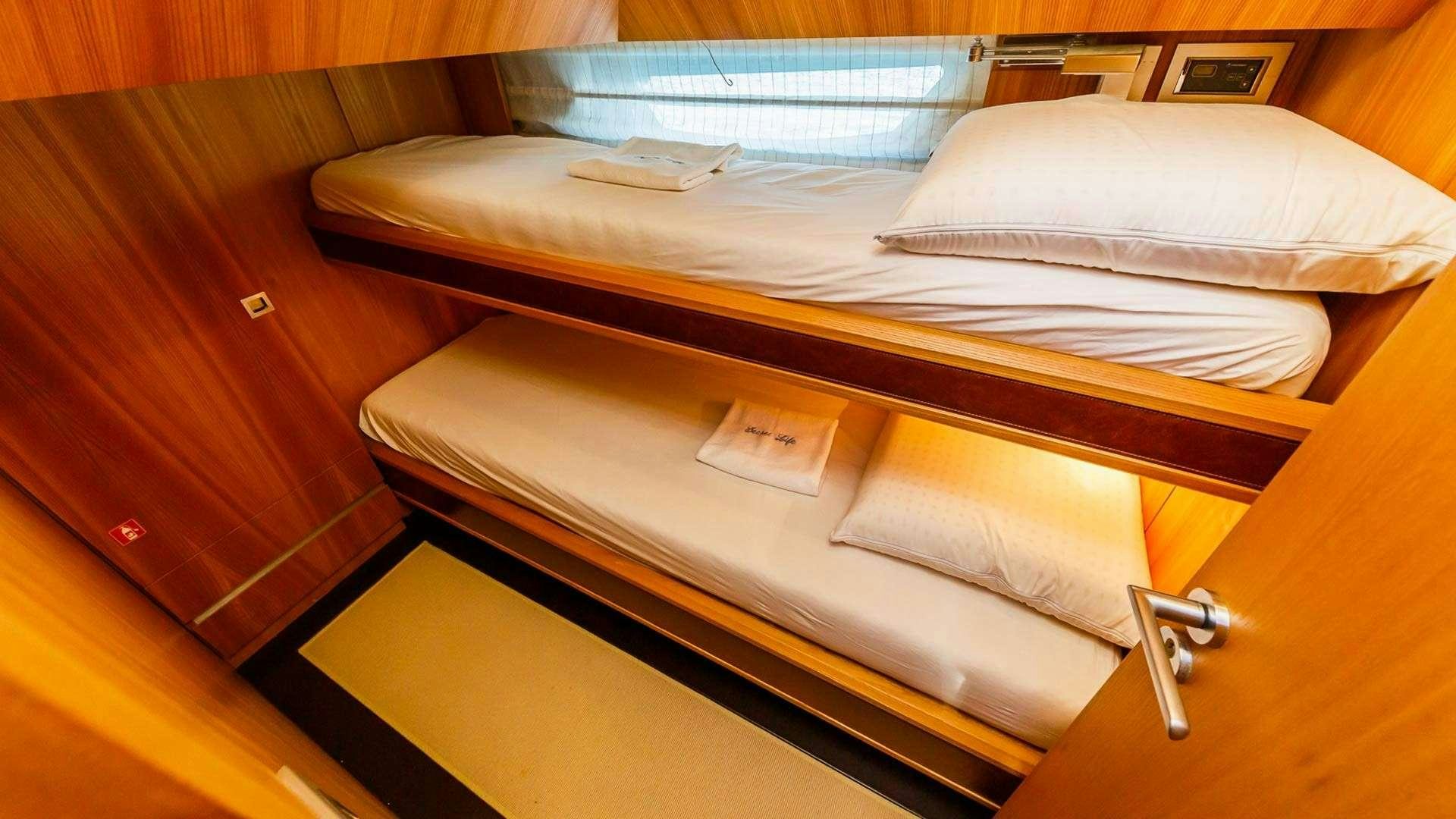 a bed with white sheets aboard SECRET LIFE Yacht for Charter