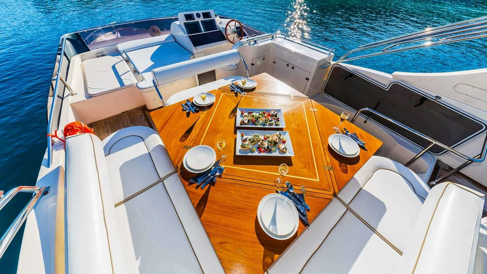 a boat with a table and chairs on it aboard SECRET LIFE Yacht for Charter