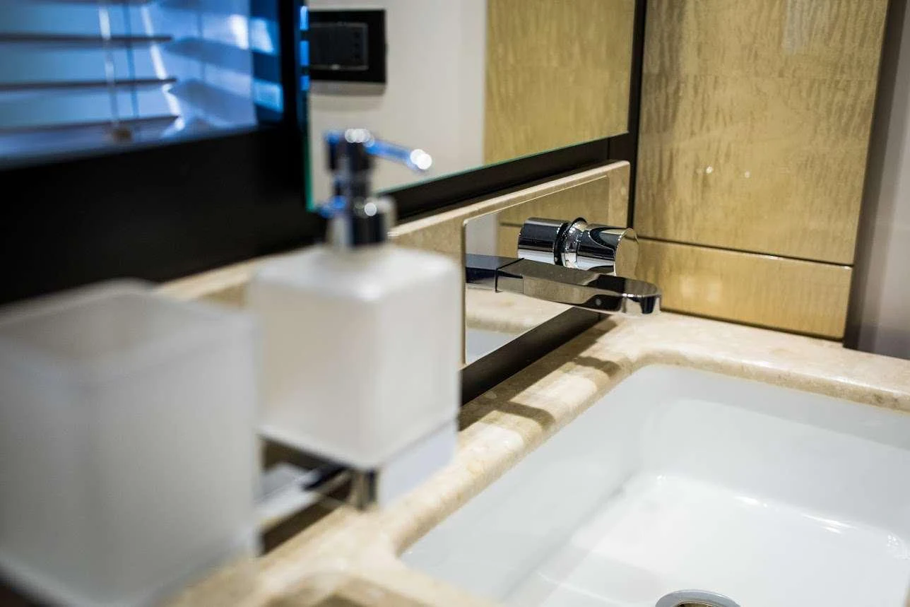 a bathroom with a toilet and a sink aboard TAMARA II Yacht for Charter