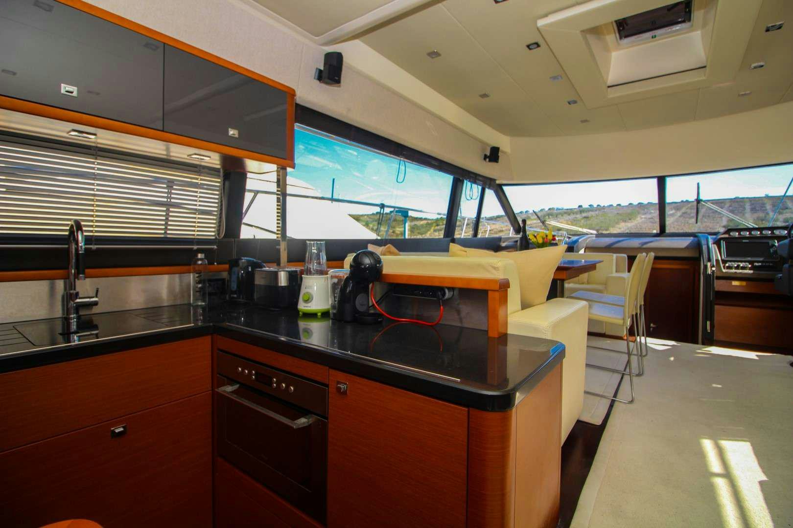 a kitchen with a large window aboard GRACE Yacht for Charter