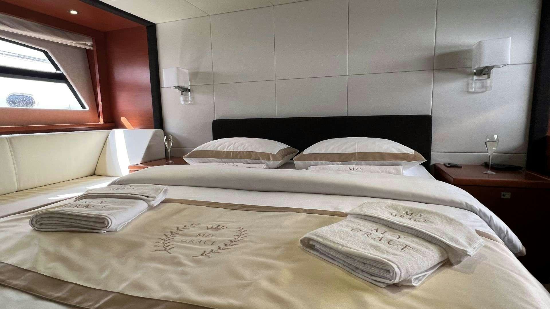 a bed with white sheets aboard GRACE Yacht for Charter
