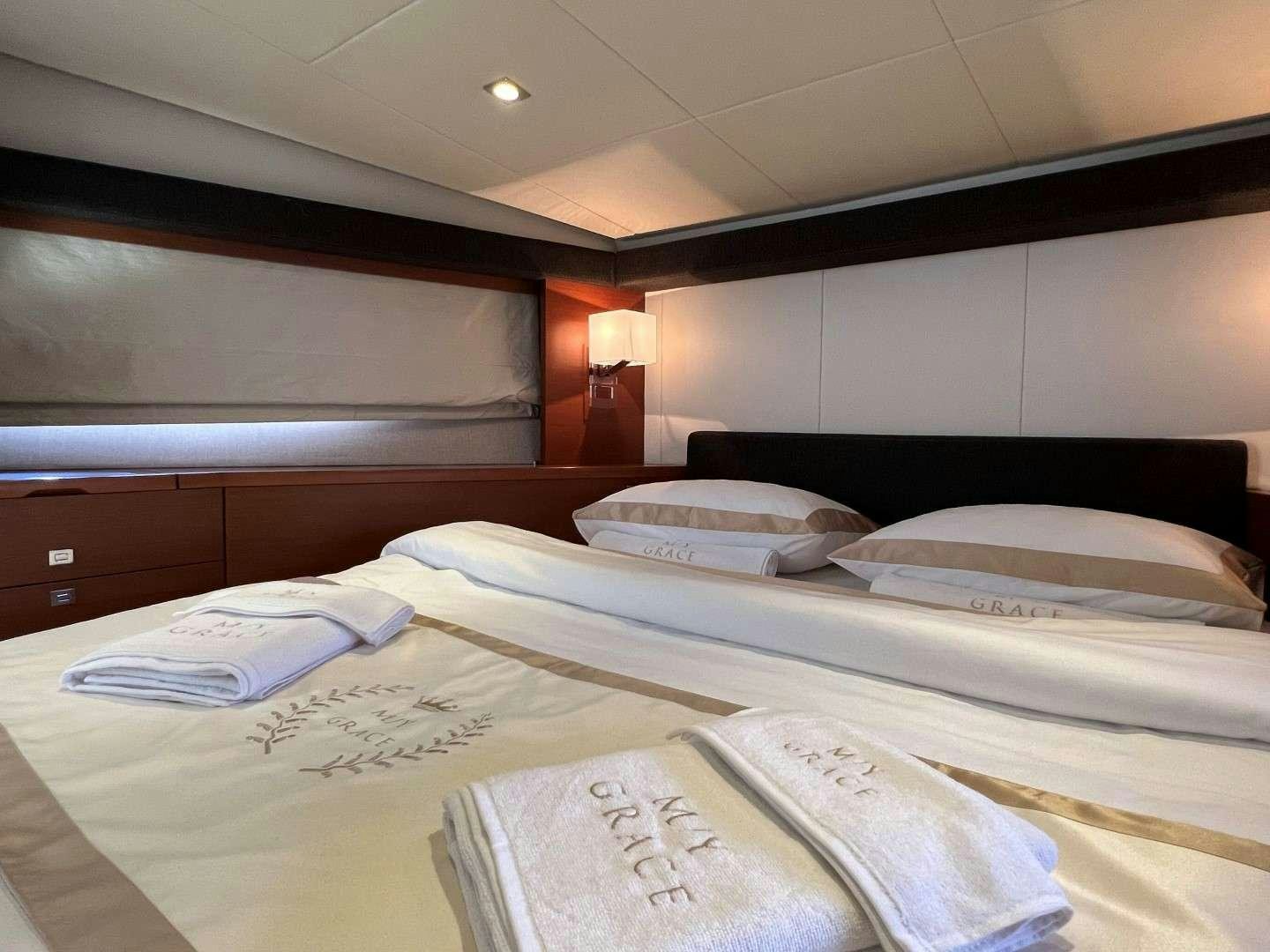 a room with a bed and a lamp aboard GRACE Yacht for Charter