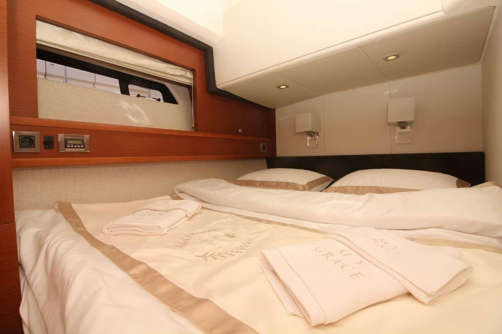 a bed with white sheets aboard GRACE Yacht for Charter