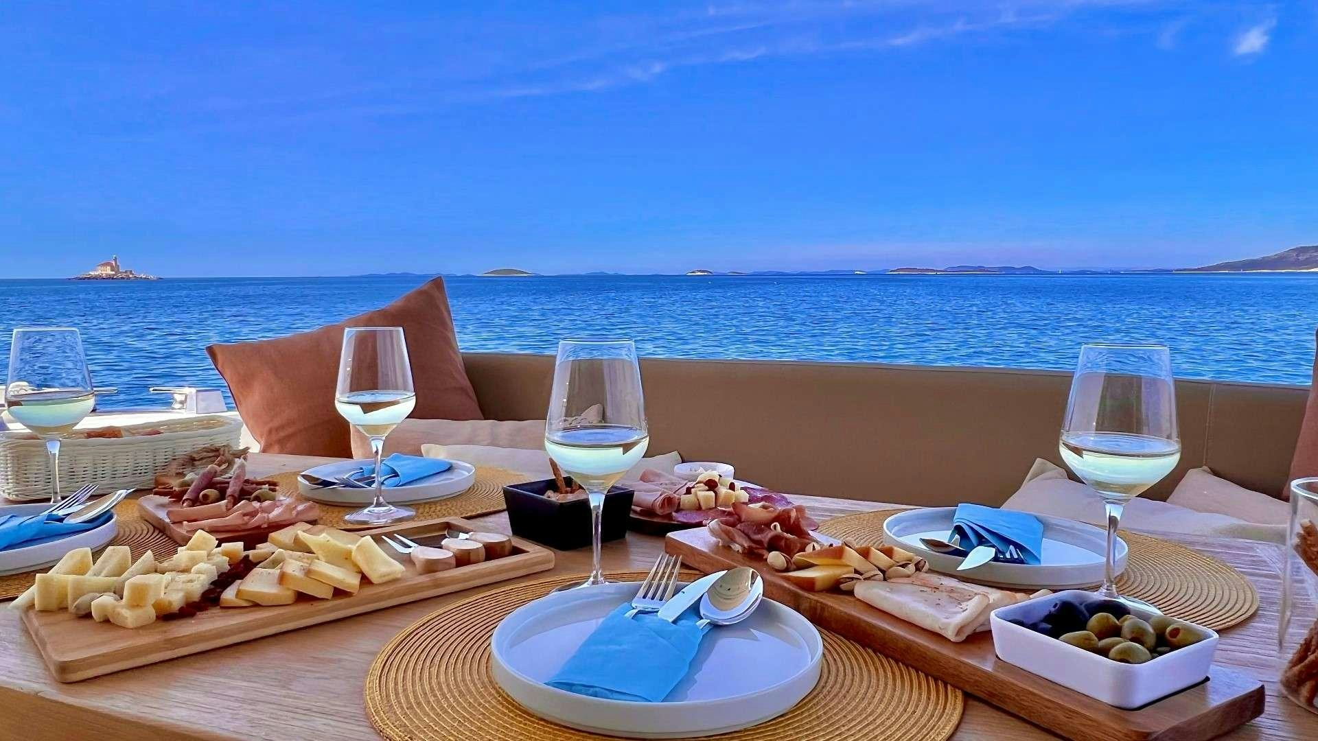 a table with food and drinks on it aboard GRACE Yacht for Charter
