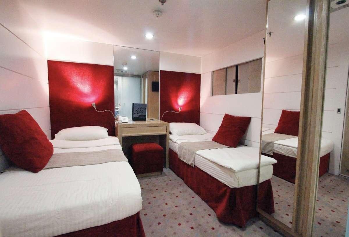 a room with a couple beds aboard HARMONY Yacht for Charter