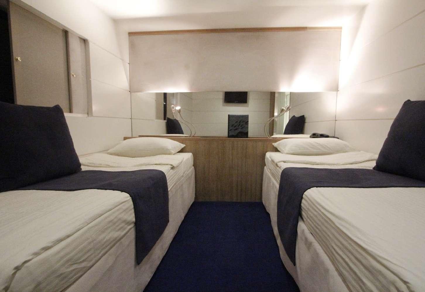 a room with several beds aboard HARMONY Yacht for Charter