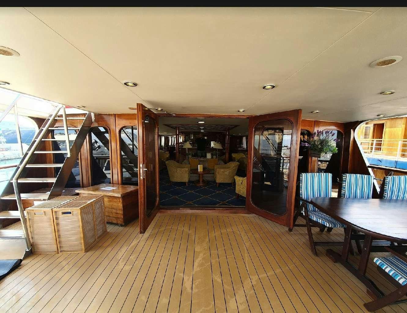 a room with a pool table and chairs aboard CALLISTO Yacht for Charter