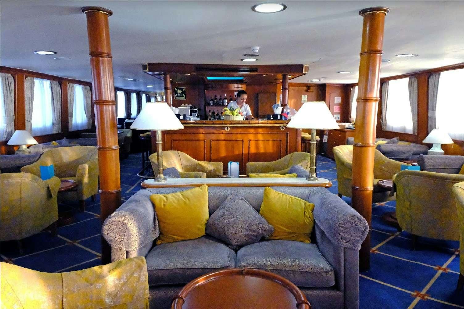 a living room with a couch and a table aboard CALLISTO Yacht for Charter