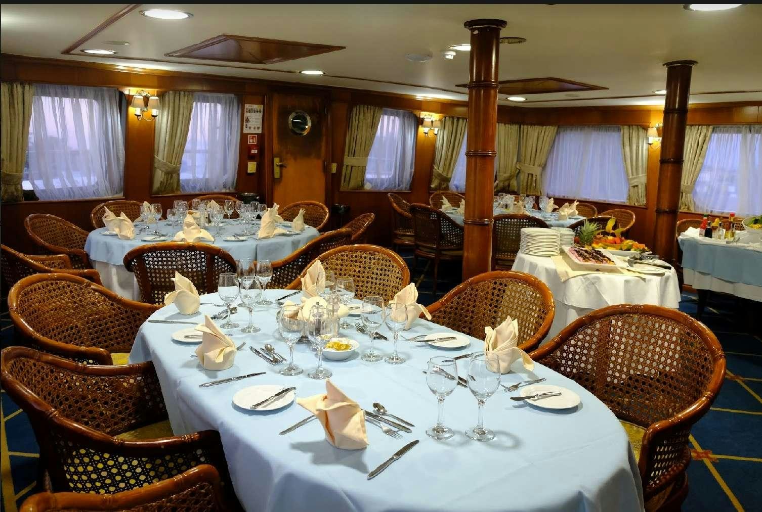 a dining room with tables and chairs aboard CALLISTO Yacht for Charter