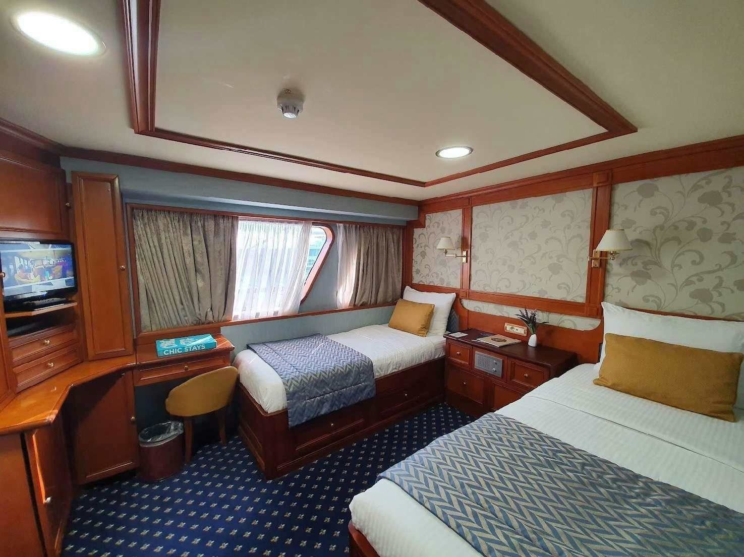 a bedroom with a couple of beds aboard CALLISTO Yacht for Charter