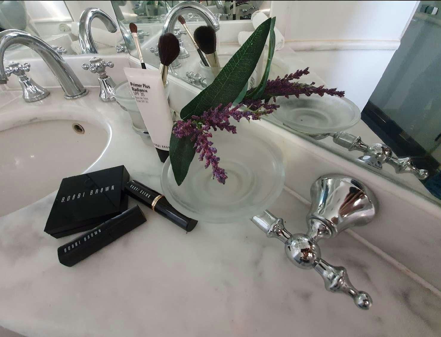 a bathroom sink with a black watch aboard CALLISTO Yacht for Charter