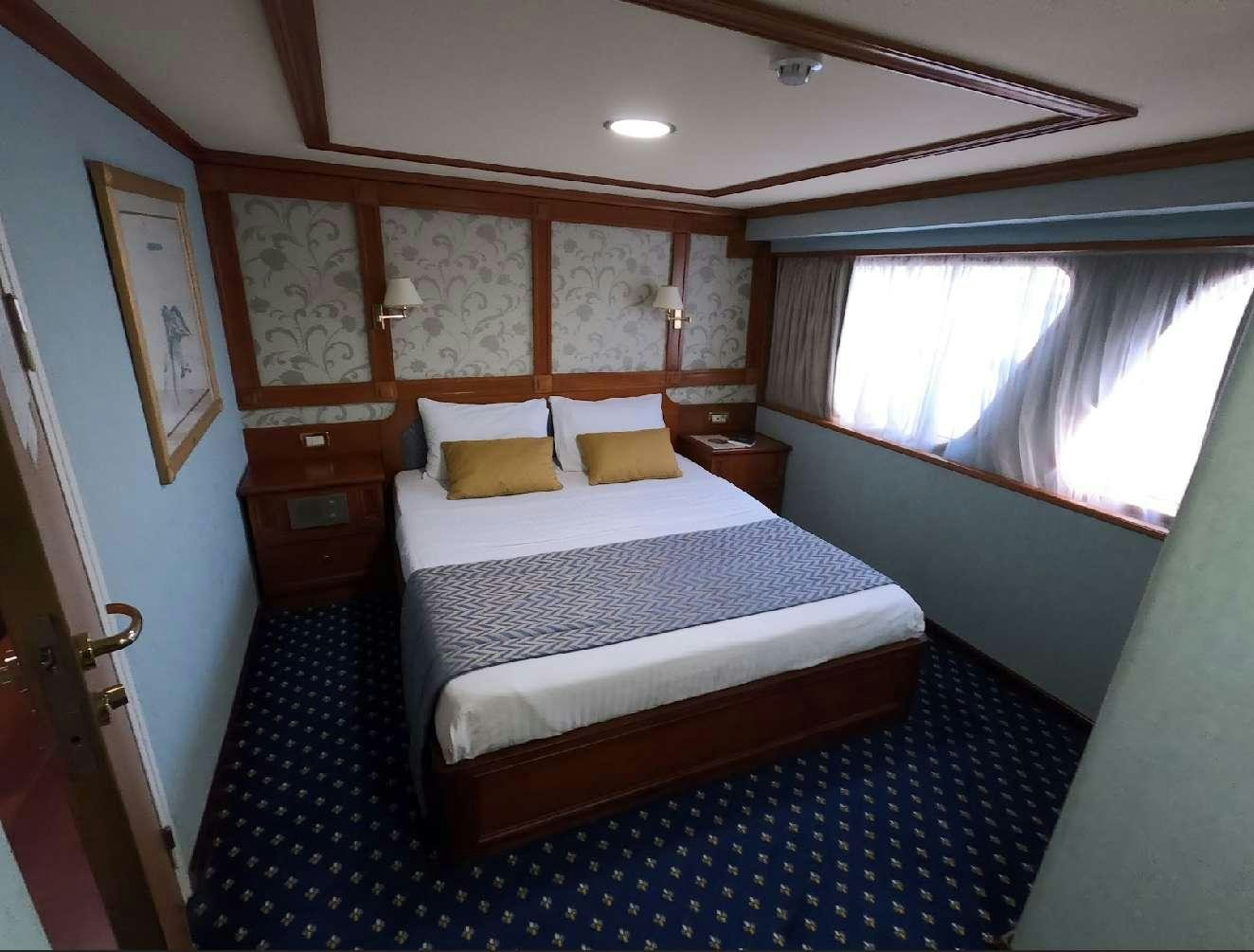 a bed in a room aboard CALLISTO Yacht for Charter