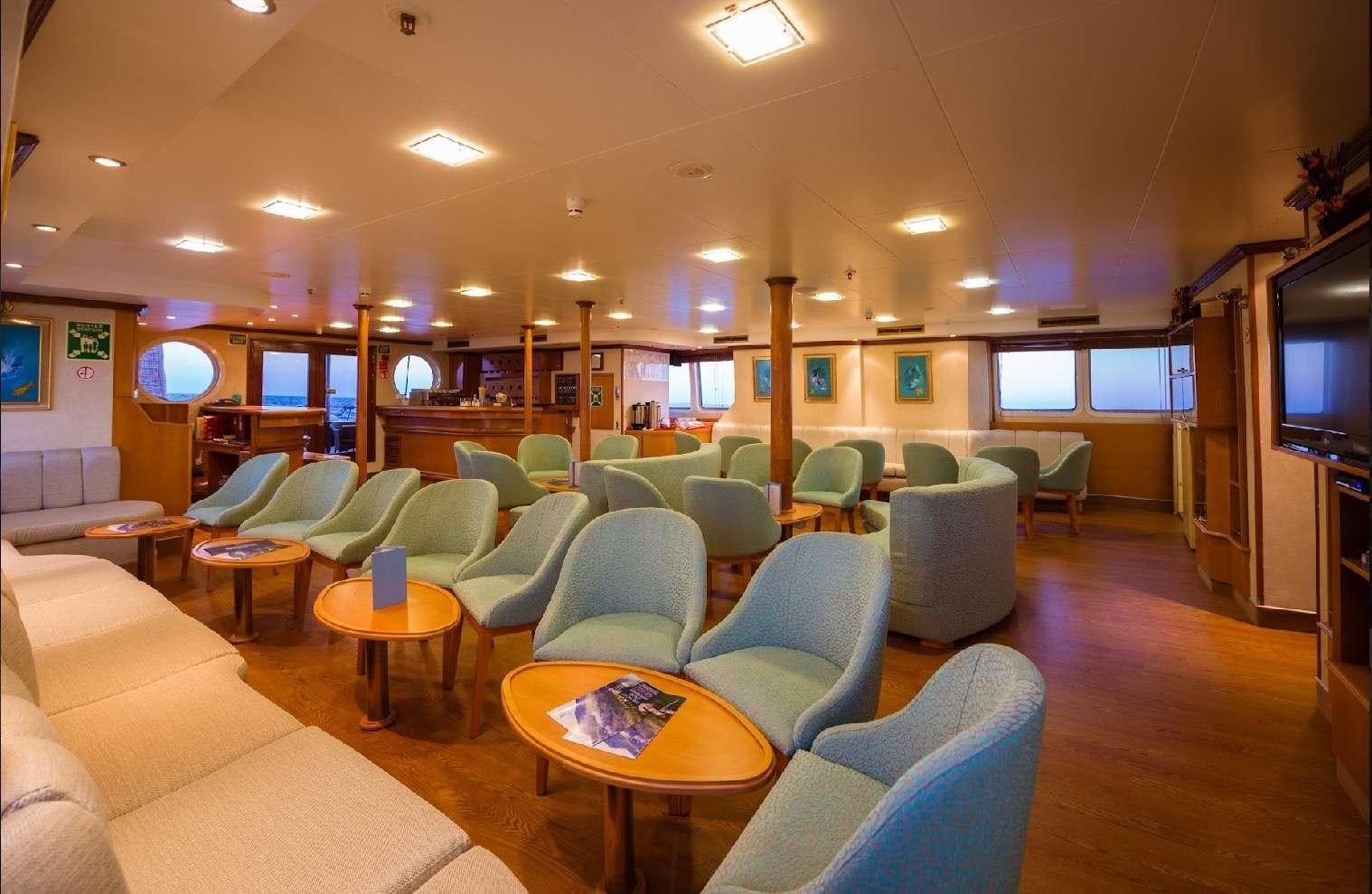 a room with a table and chairs aboard PAN ORAMA II Yacht for Charter