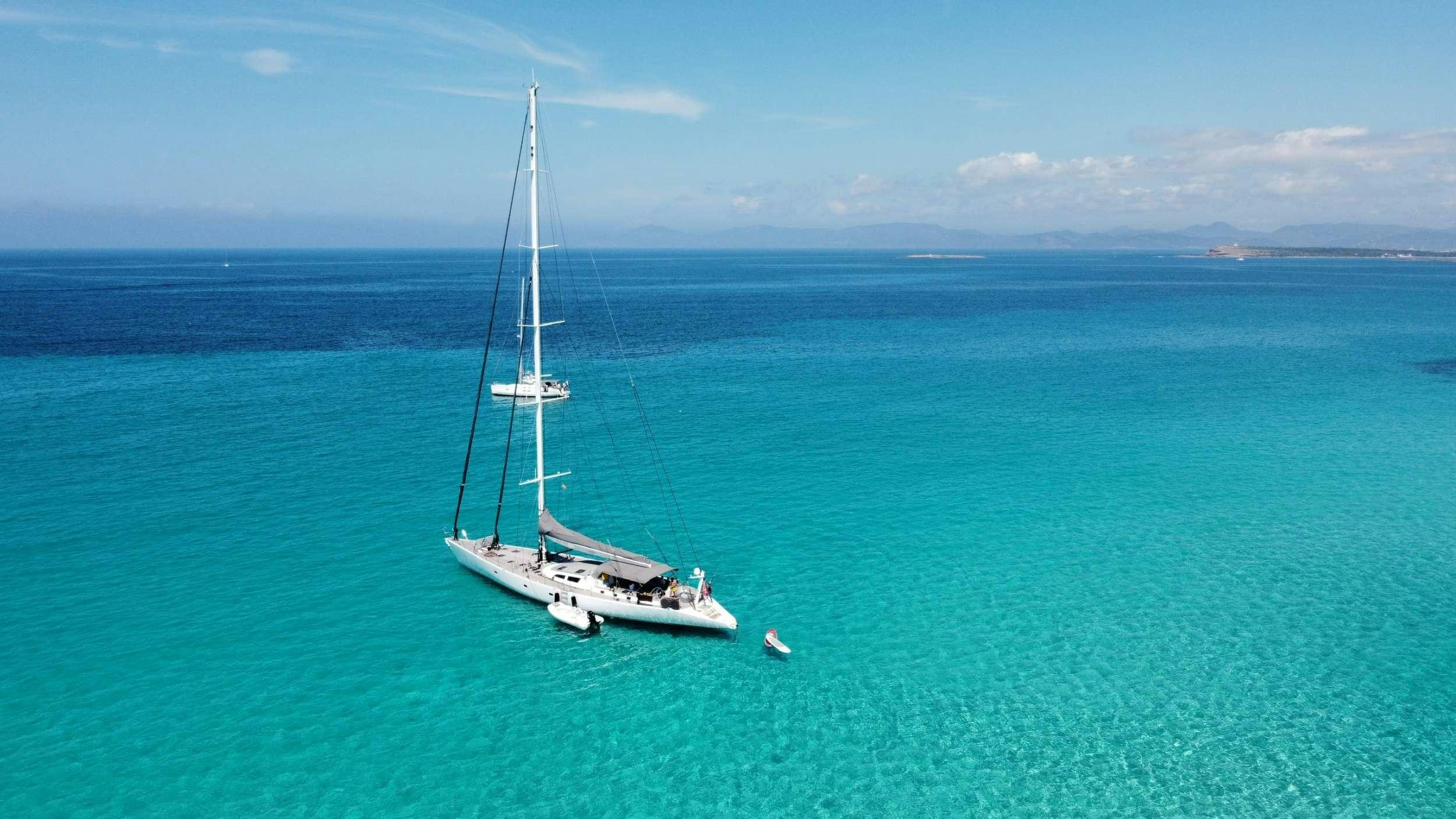 a sailboat in the ocean aboard AIZU Yacht for Charter