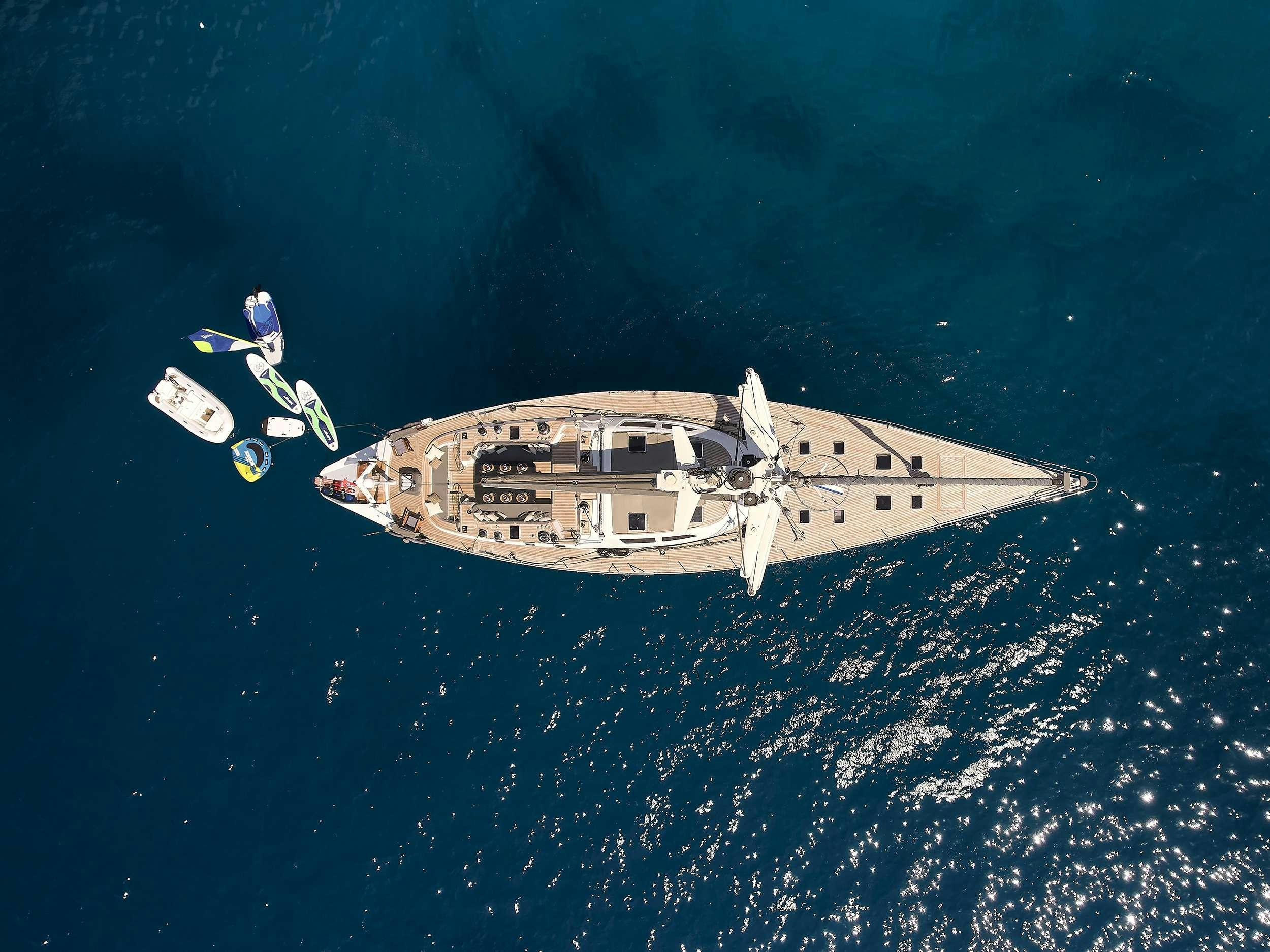 a person in a space suit flying over a ship in the ocean aboard AIZU Yacht for Charter
