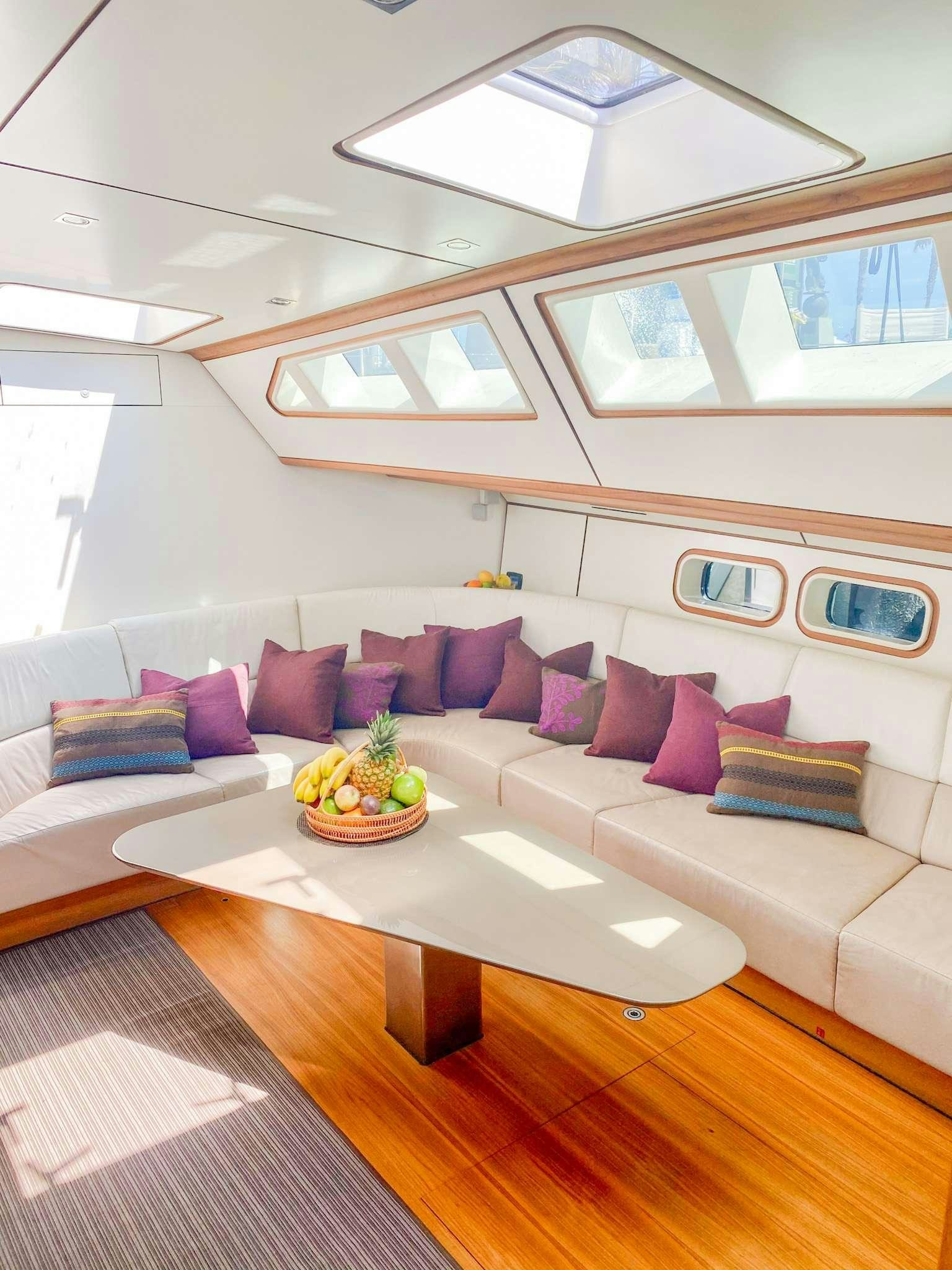 a living room with a couch and a coffee table aboard AIZU Yacht for Charter