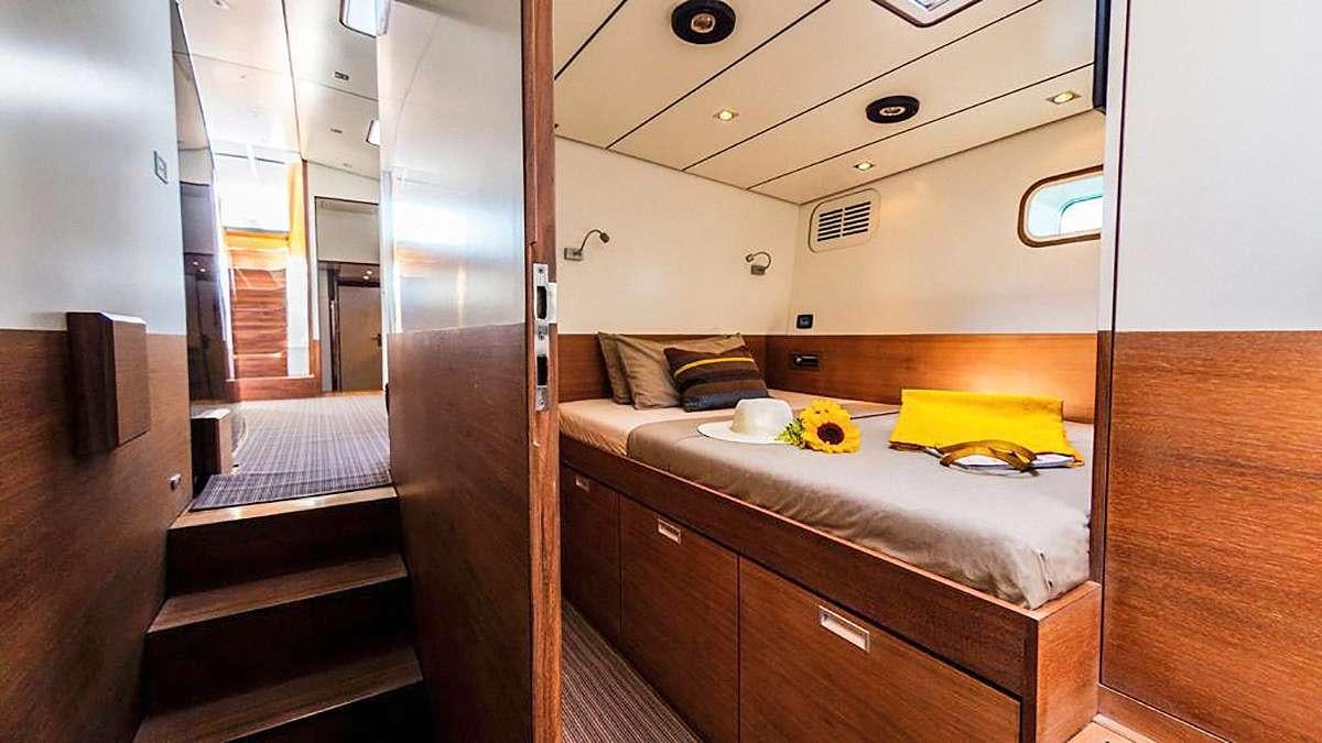 a room with a bed and a desk aboard AIZU Yacht for Charter