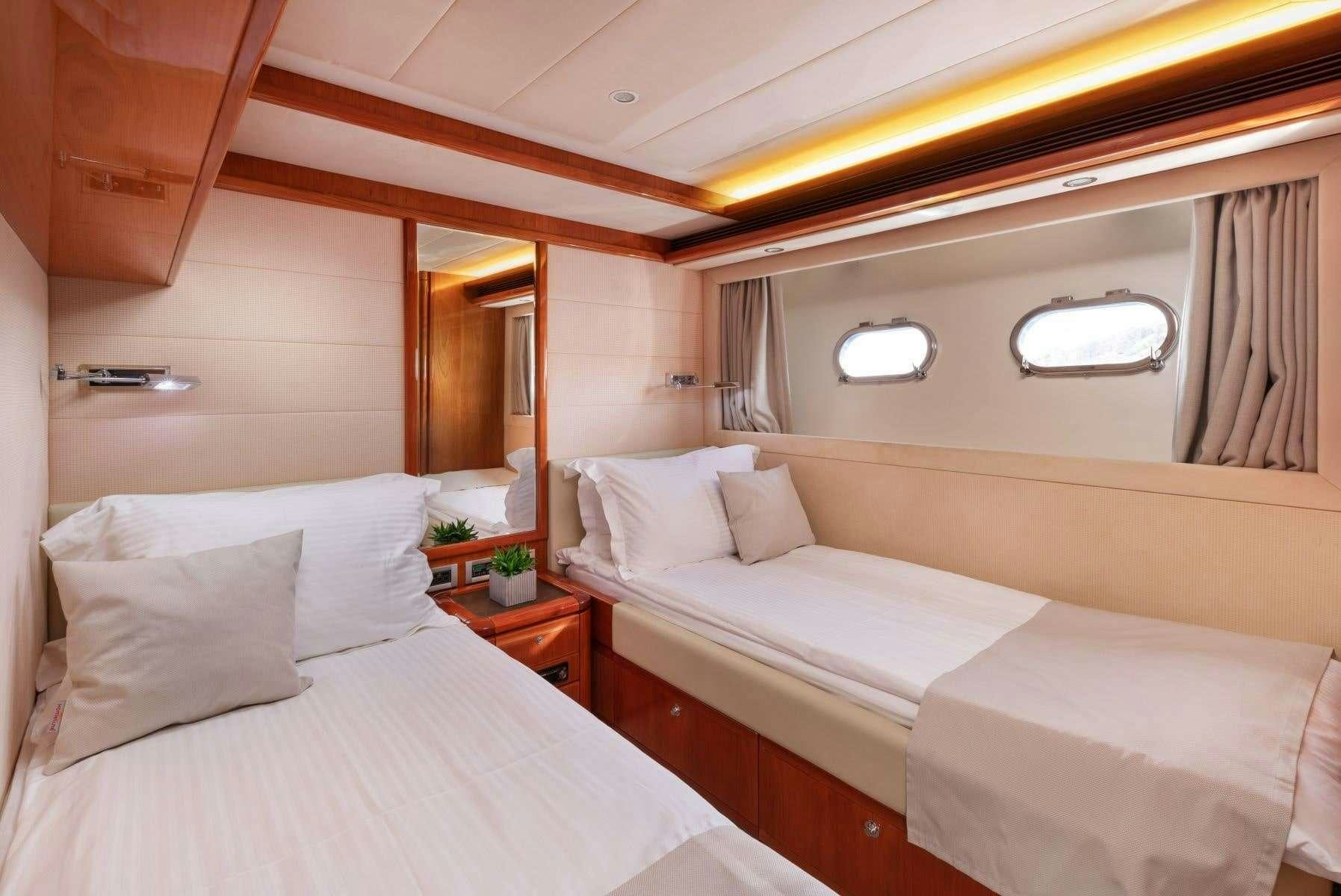 a room with two beds aboard ANNOUKA Yacht for Charter