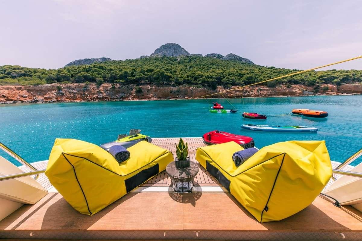 yellow and red kayaks on a beach aboard ANNOUKA Yacht for Charter