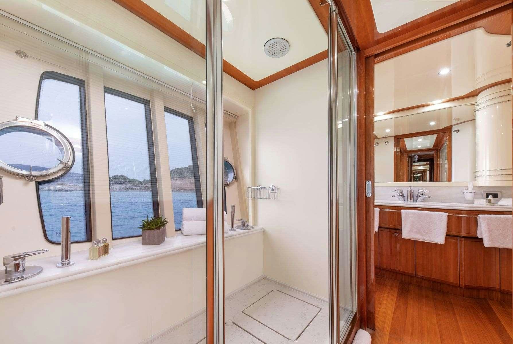 a bathroom with a tub sink and a shower aboard ANNOUKA Yacht for Charter