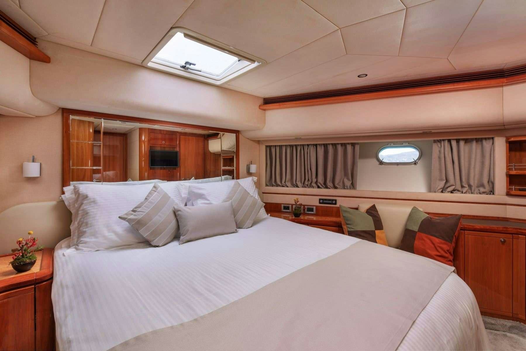 a room with a bed and a desk aboard ANNOUKA Yacht for Charter
