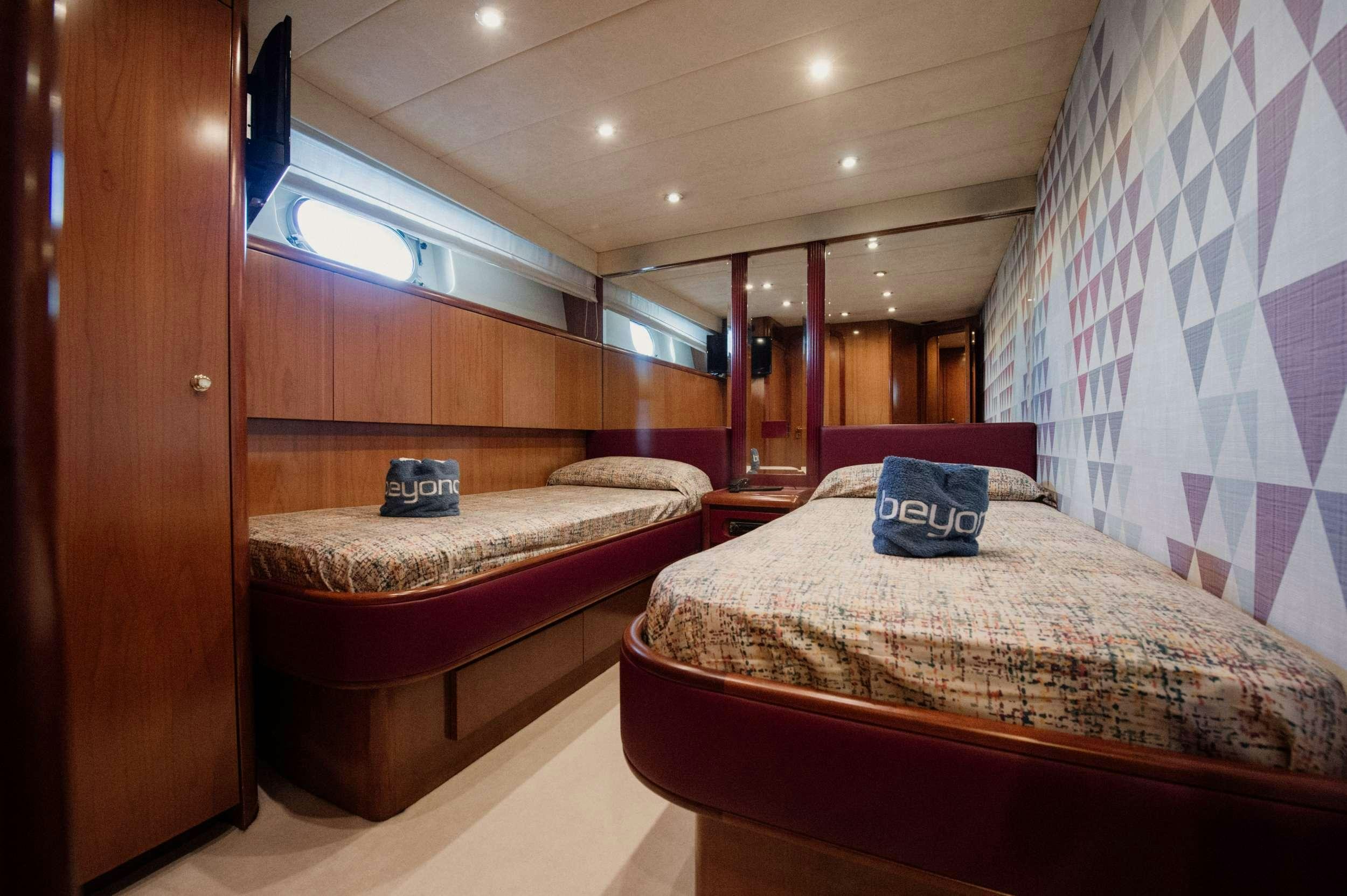 a couple of beds in a room aboard BEYOND Yacht for Charter