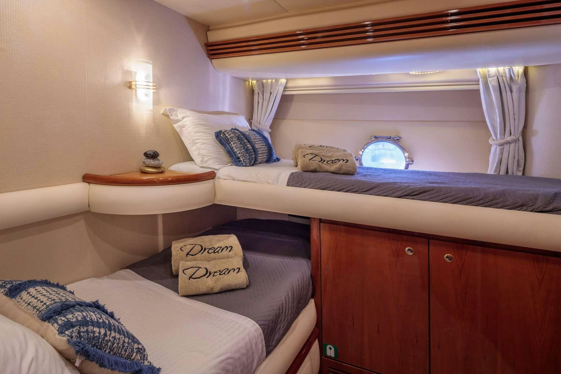 a room with a bed and a table aboard DREAM Yacht for Charter