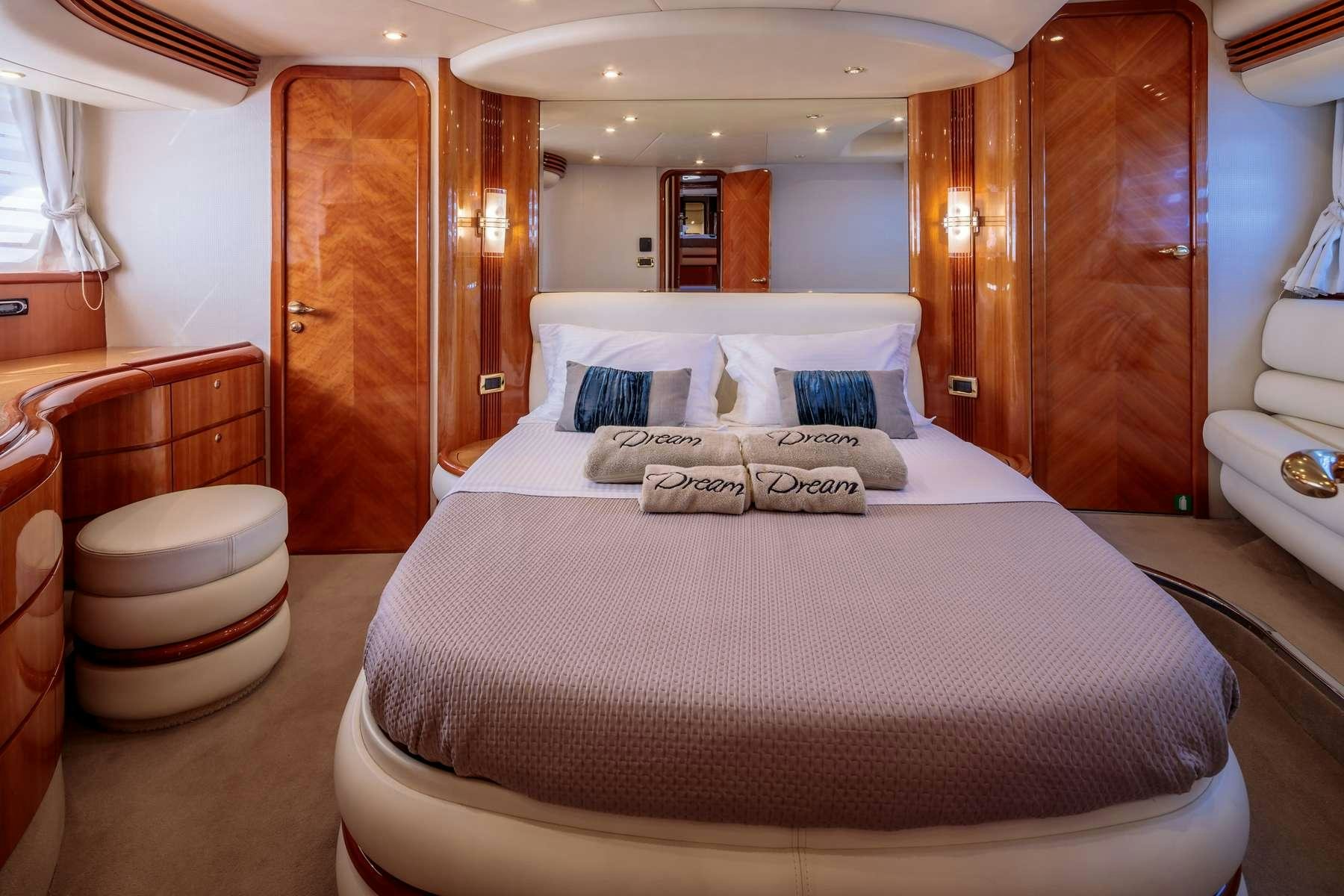 a bed with white sheets aboard DREAM Yacht for Charter