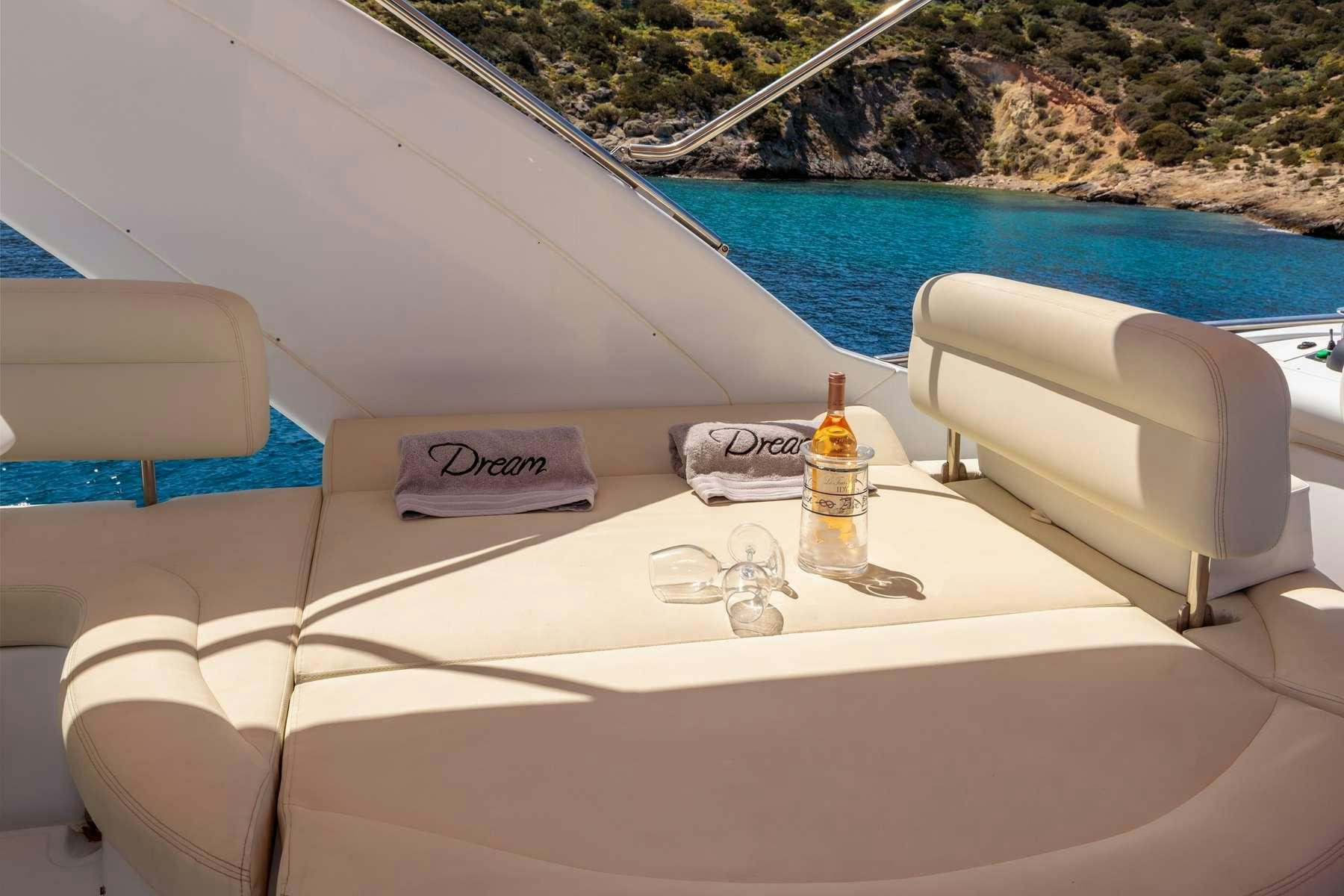 a white lounge chair on a boat aboard DREAM Yacht for Charter