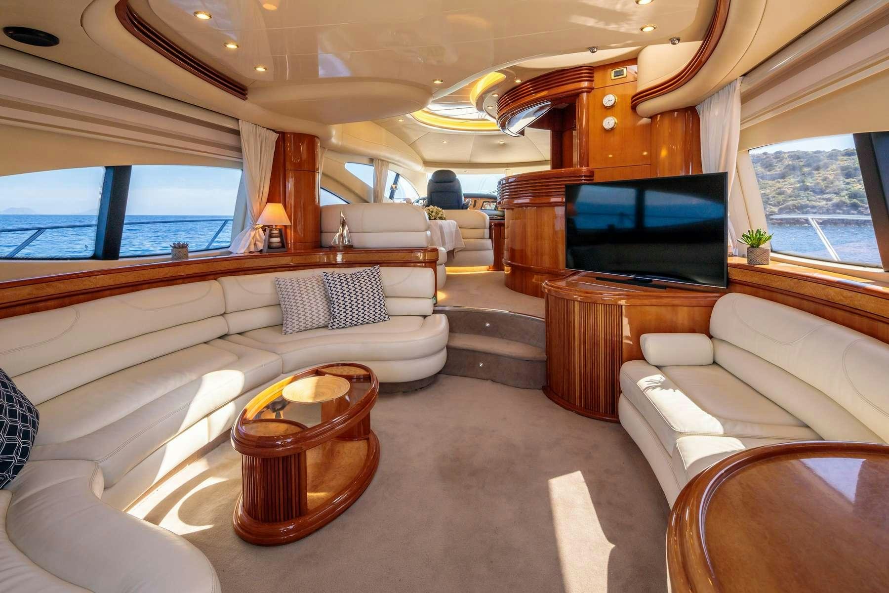 a living room with a couch and a television aboard DREAM Yacht for Charter