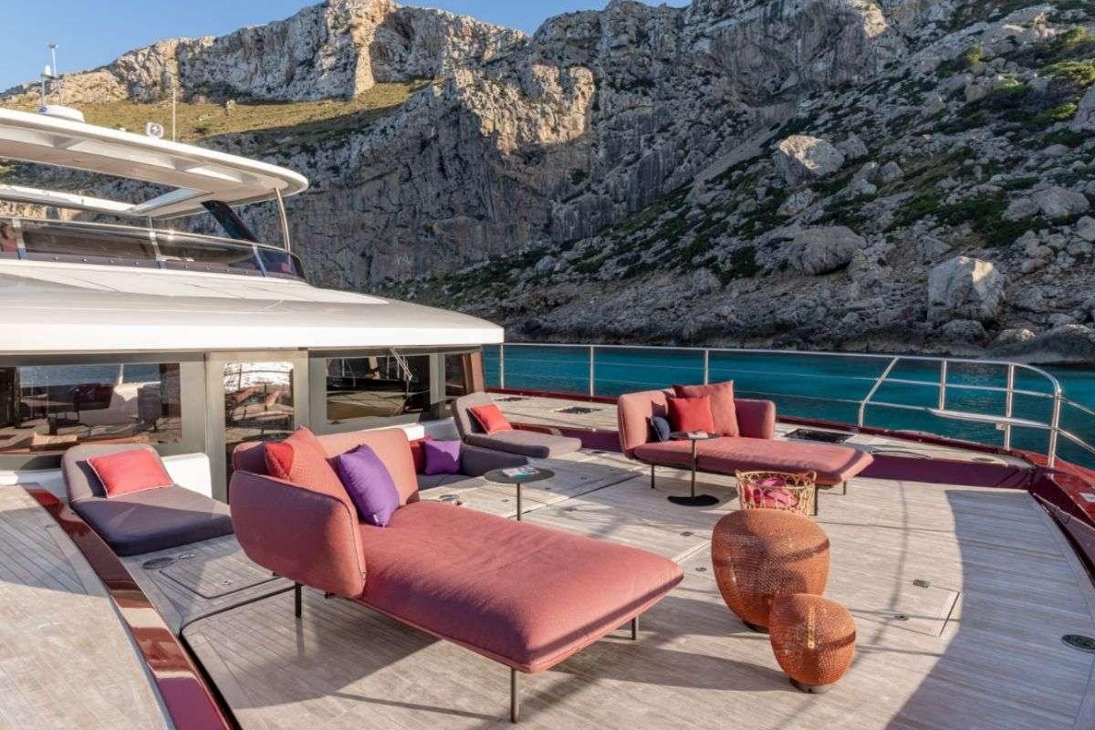 a lounge area with a large body of water in the background aboard VALIUM 67 Yacht for Charter
