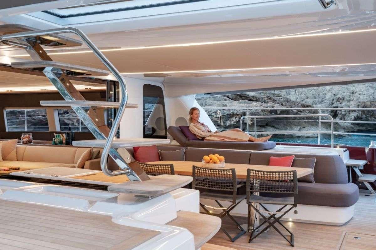 a room with a ladder and chairs aboard VALIUM 67 Yacht for Charter